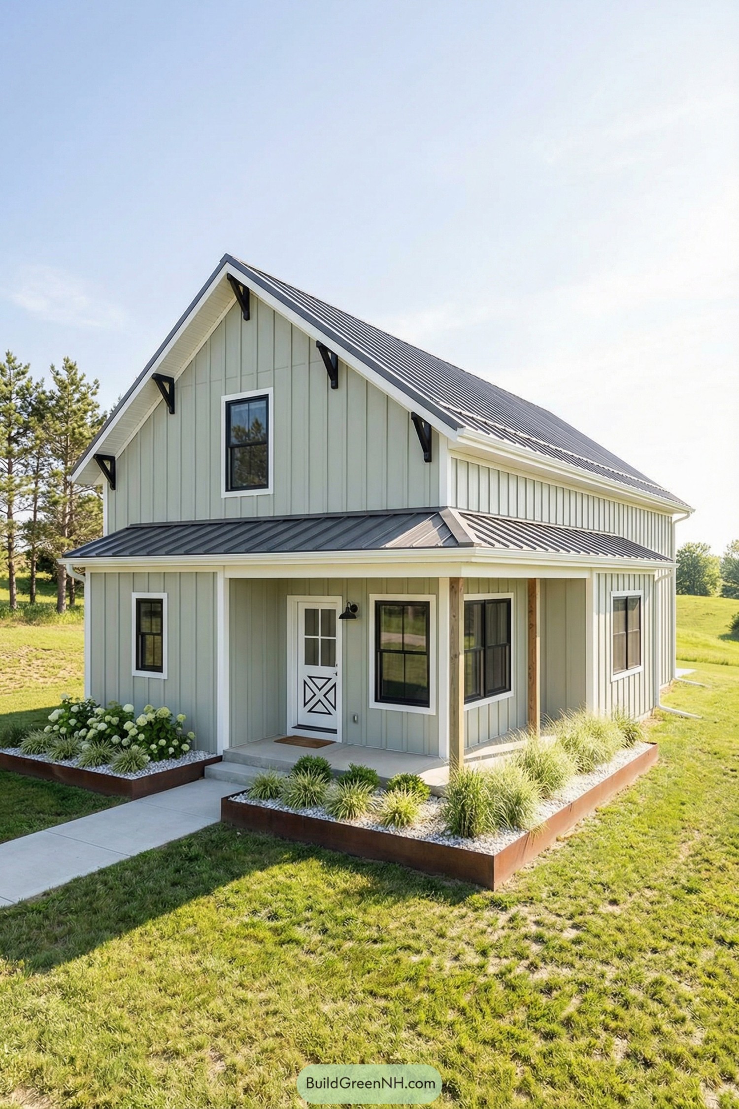 Light green modern farmhouse barndominium with black metal roof and simple landscaping