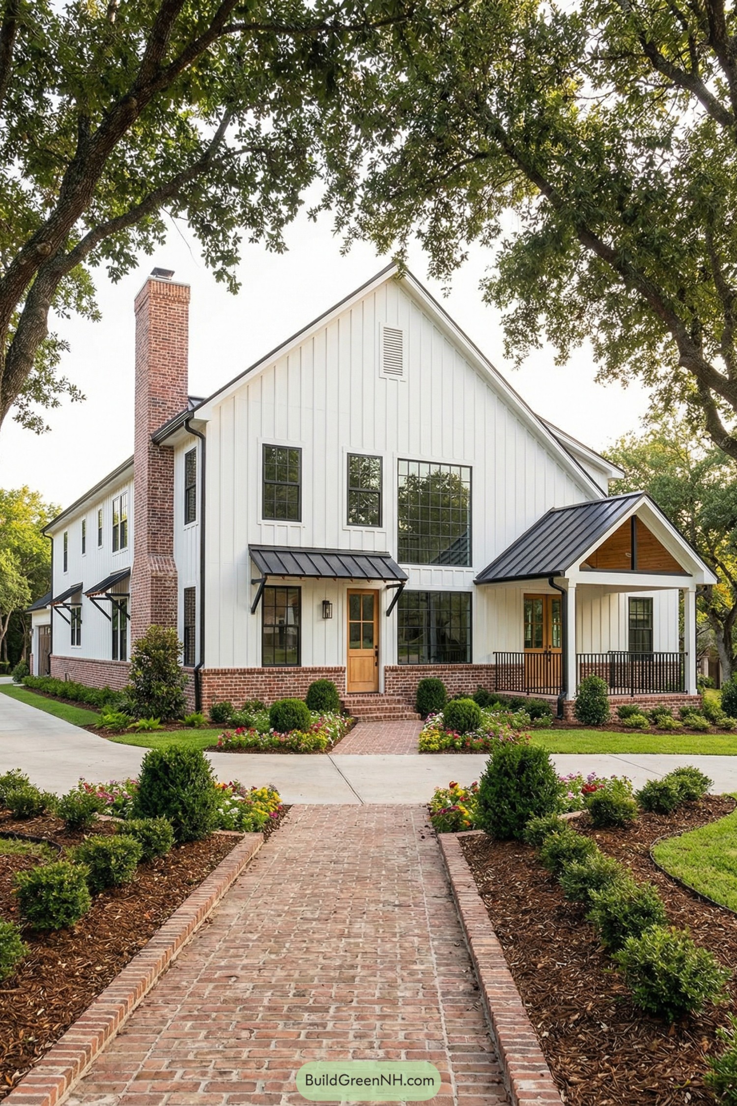 Modern white farmhouse barndominium with brick base