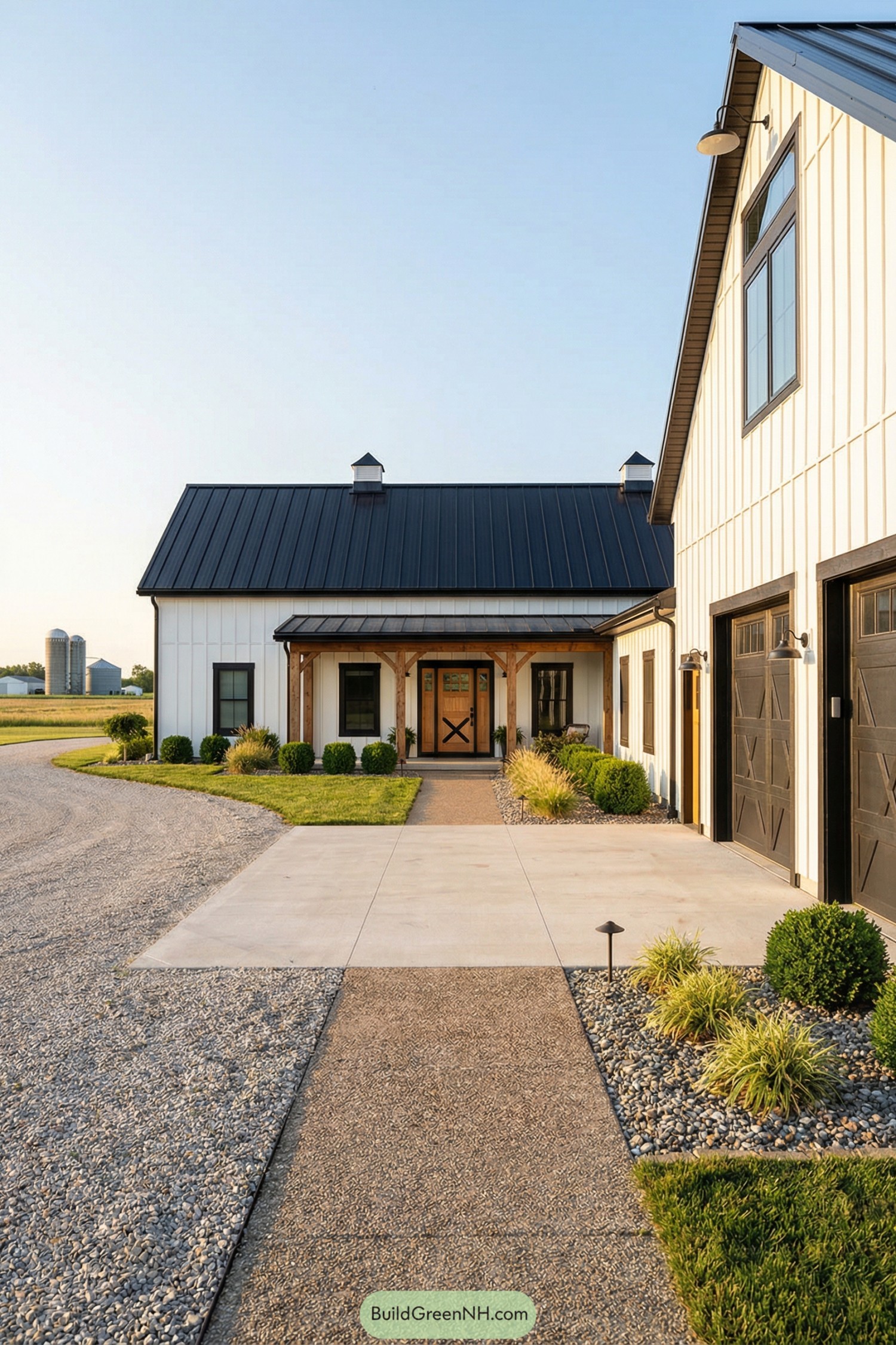Modern farmhouse barndominium with black metal roof, white siding, and timber front porch