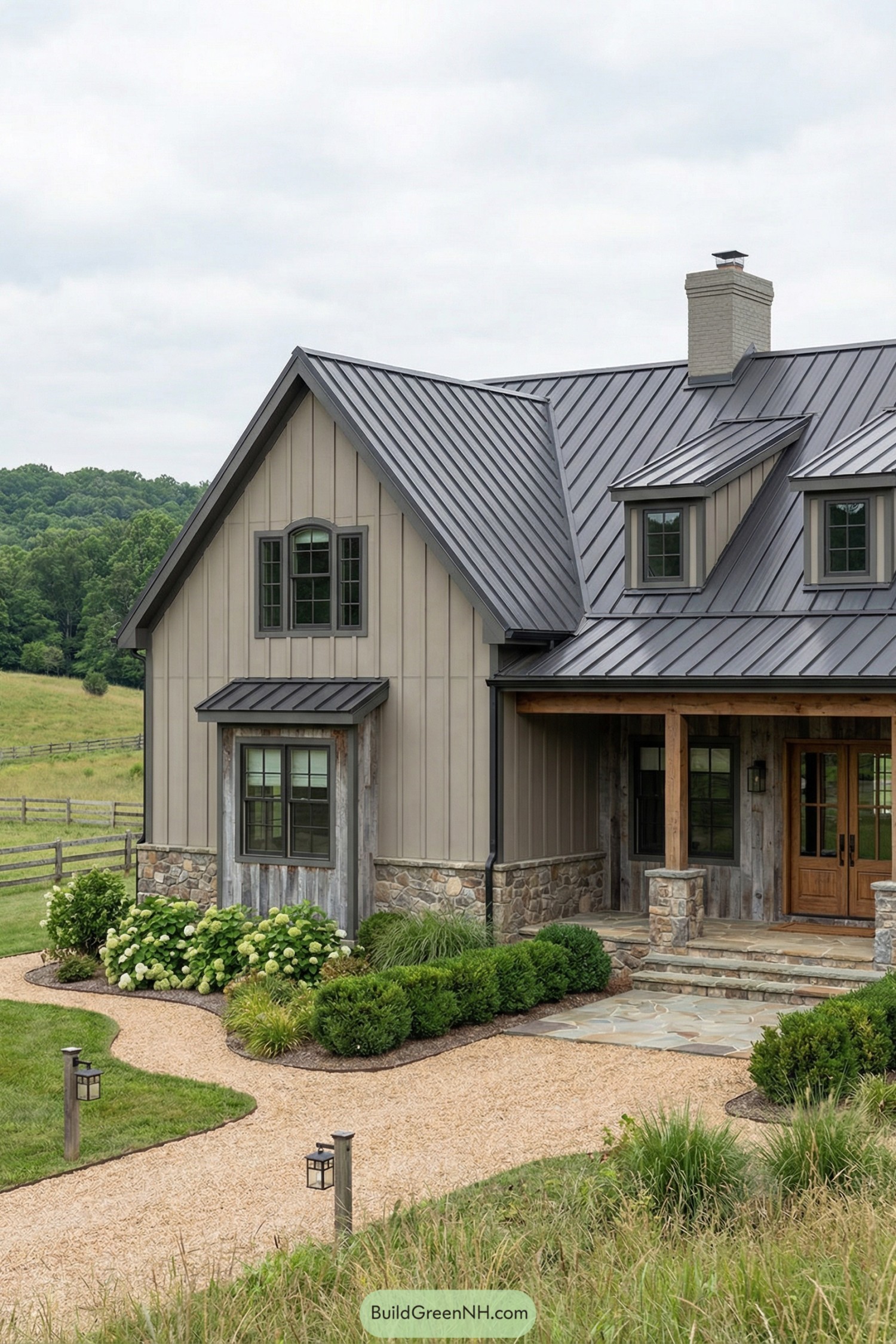 Grey barndominium with metal roof and stone accents