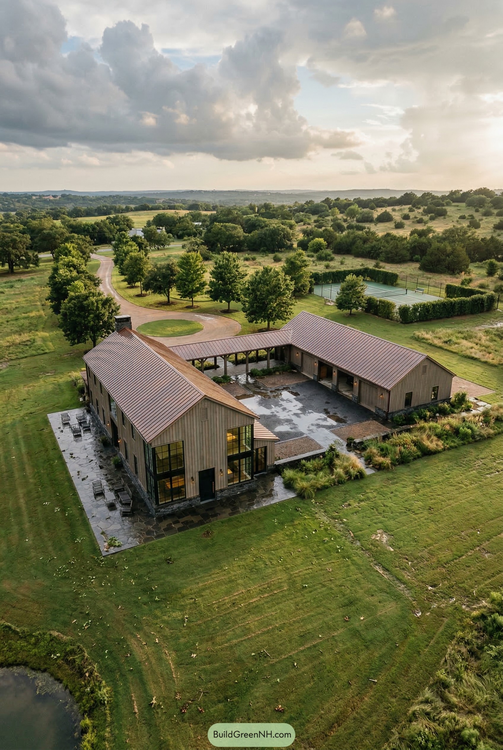 Aerial view of a courtyard barndominium on open ranch land