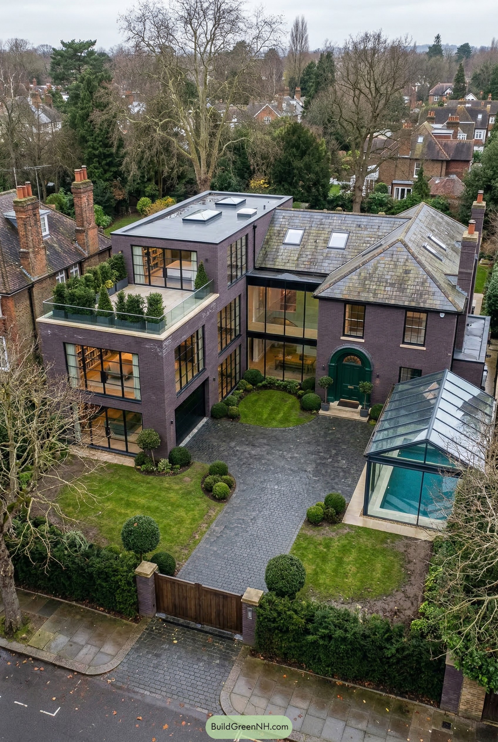 Brick mansion with modern wing and glass pool pavilion