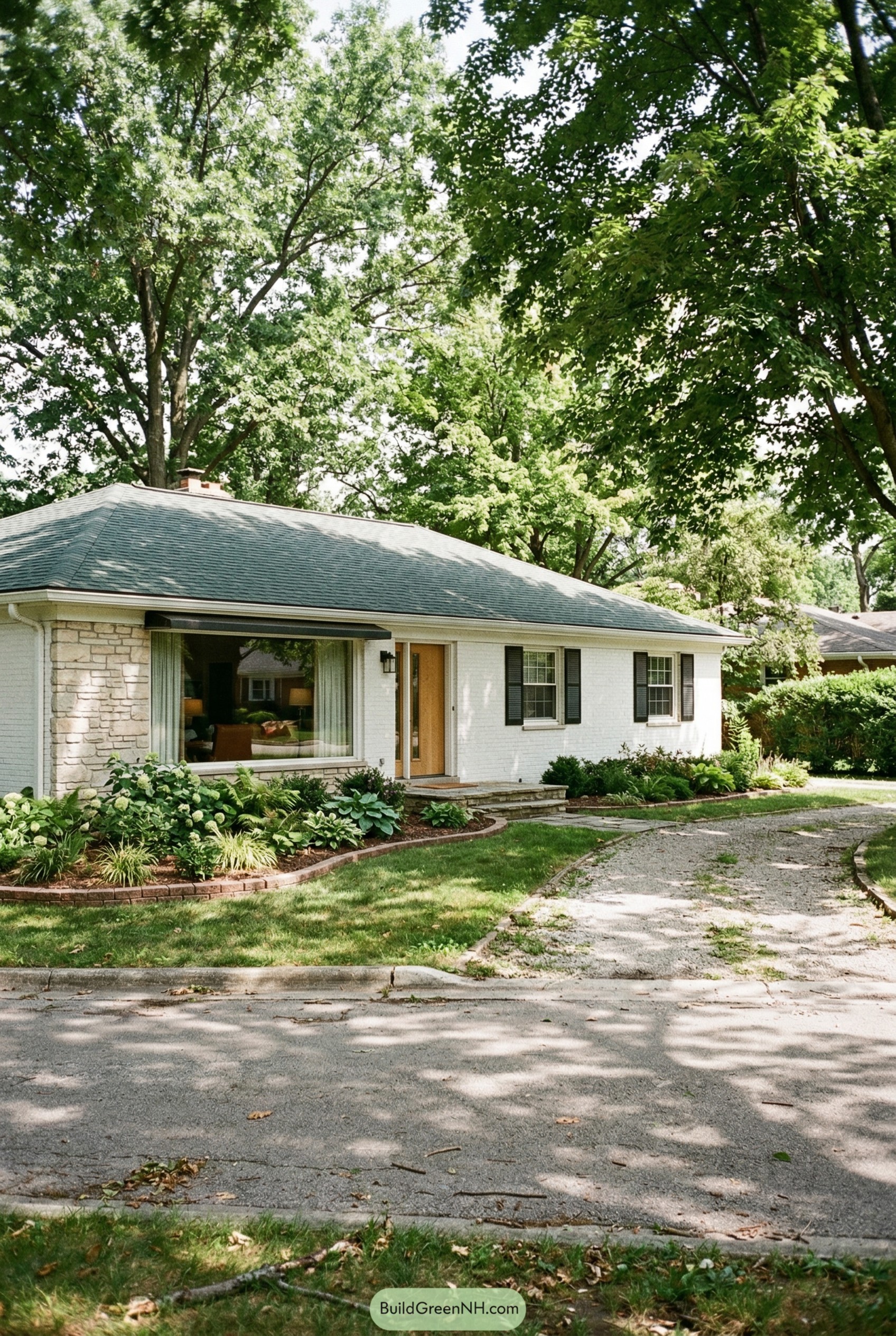 White brick ranch home under mature trees