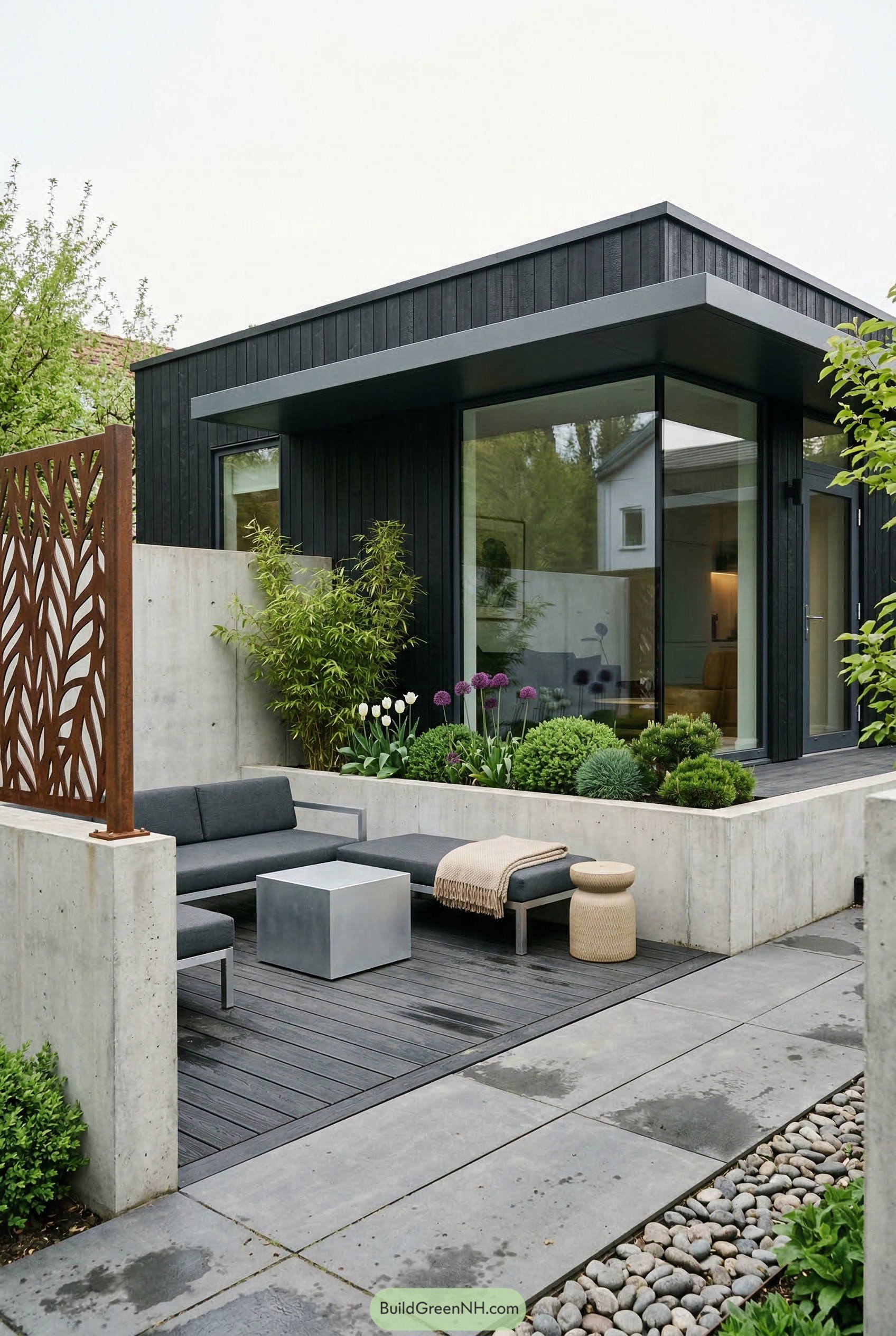 Low deck lounge with concrete planters and black facade