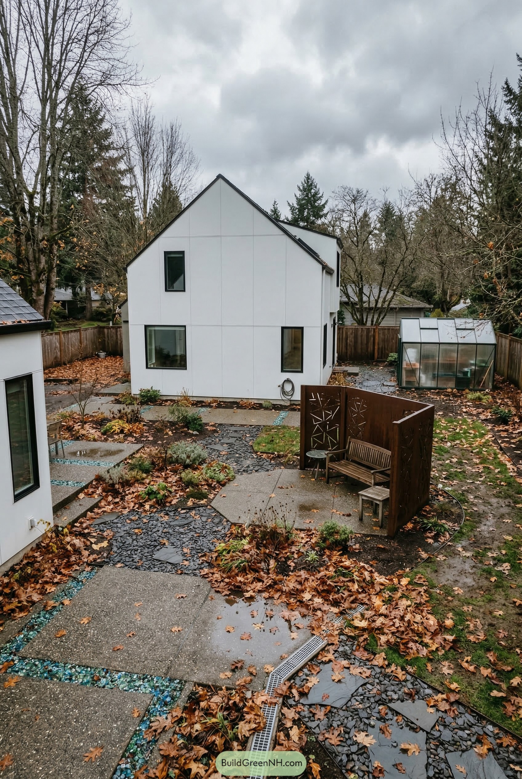 Modern white house with angular paths and corten seating nook