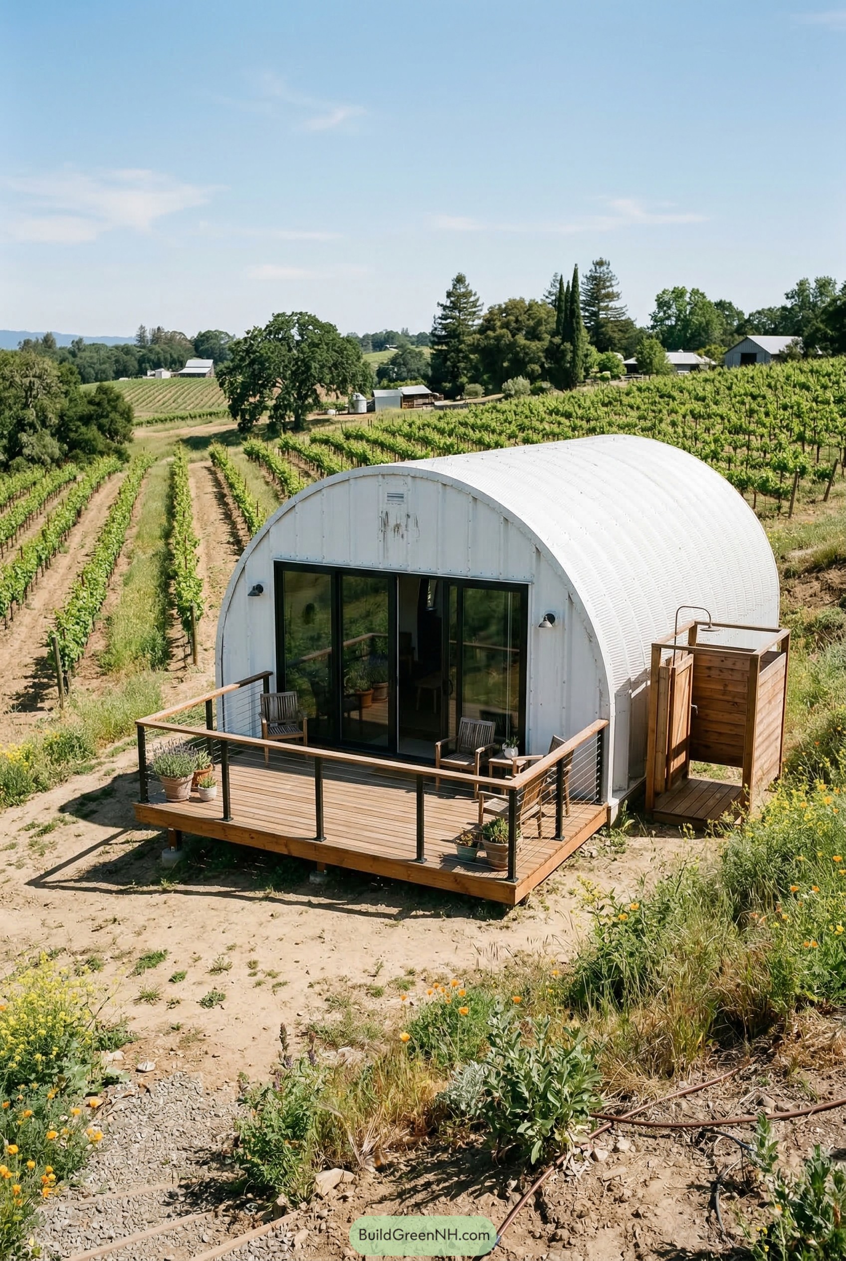White quonset hut with deck in vineyard