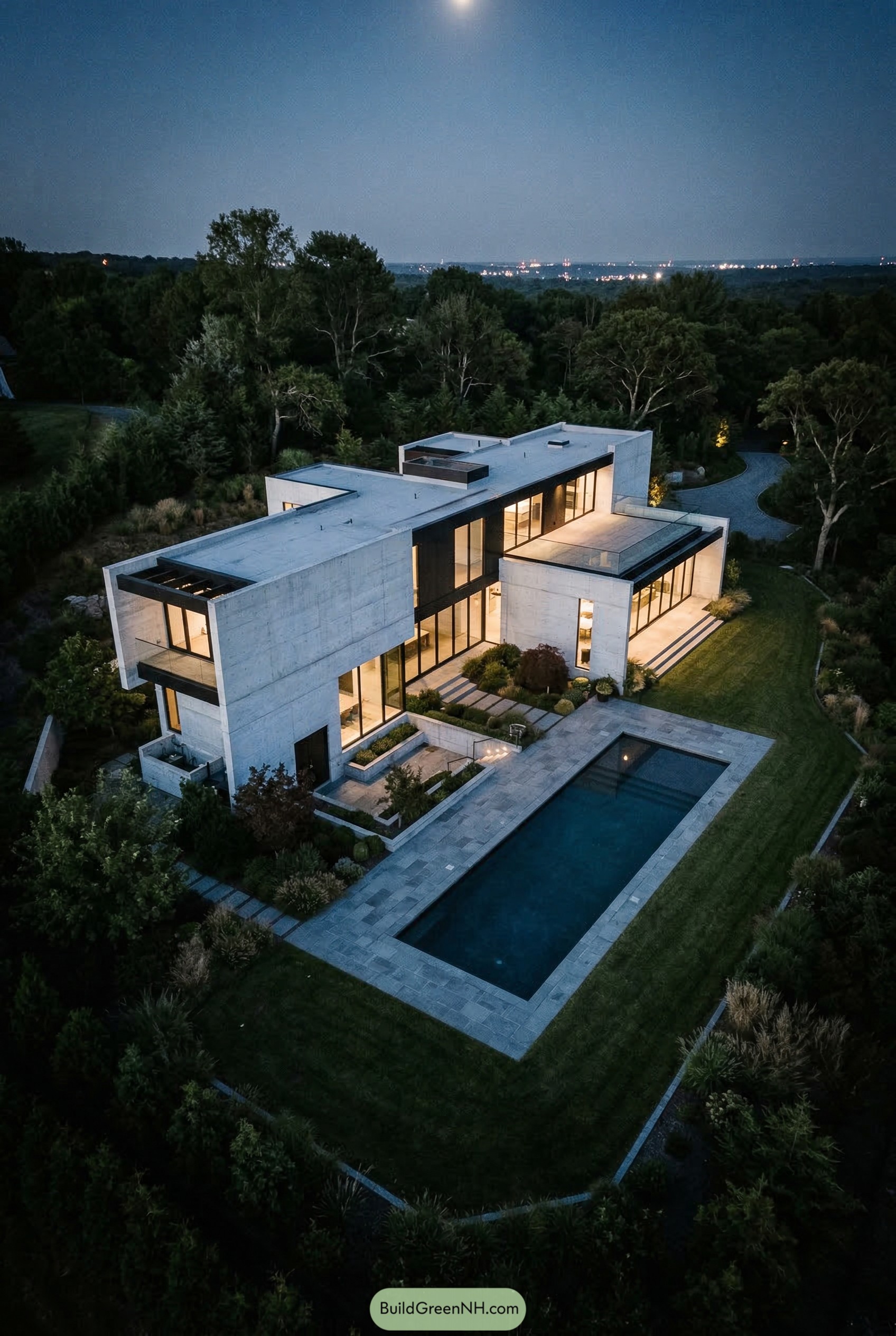 Modern concrete mansion with lap pool at dusk