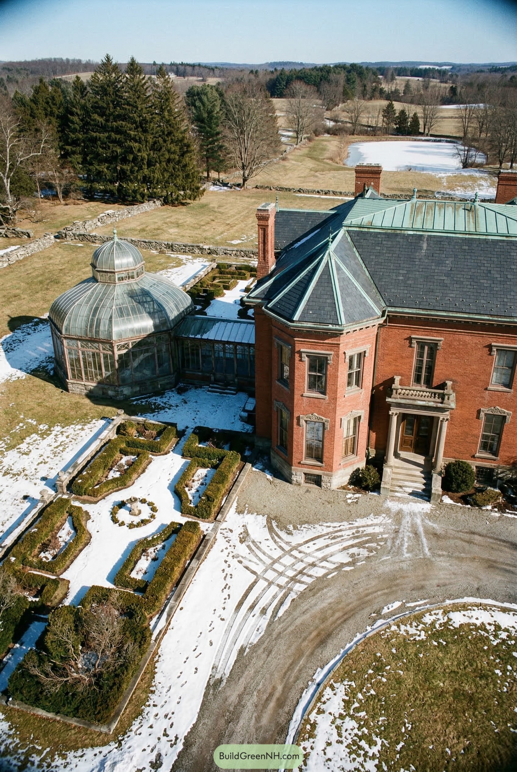 Aerial view of red brick mansion with domed conservatory