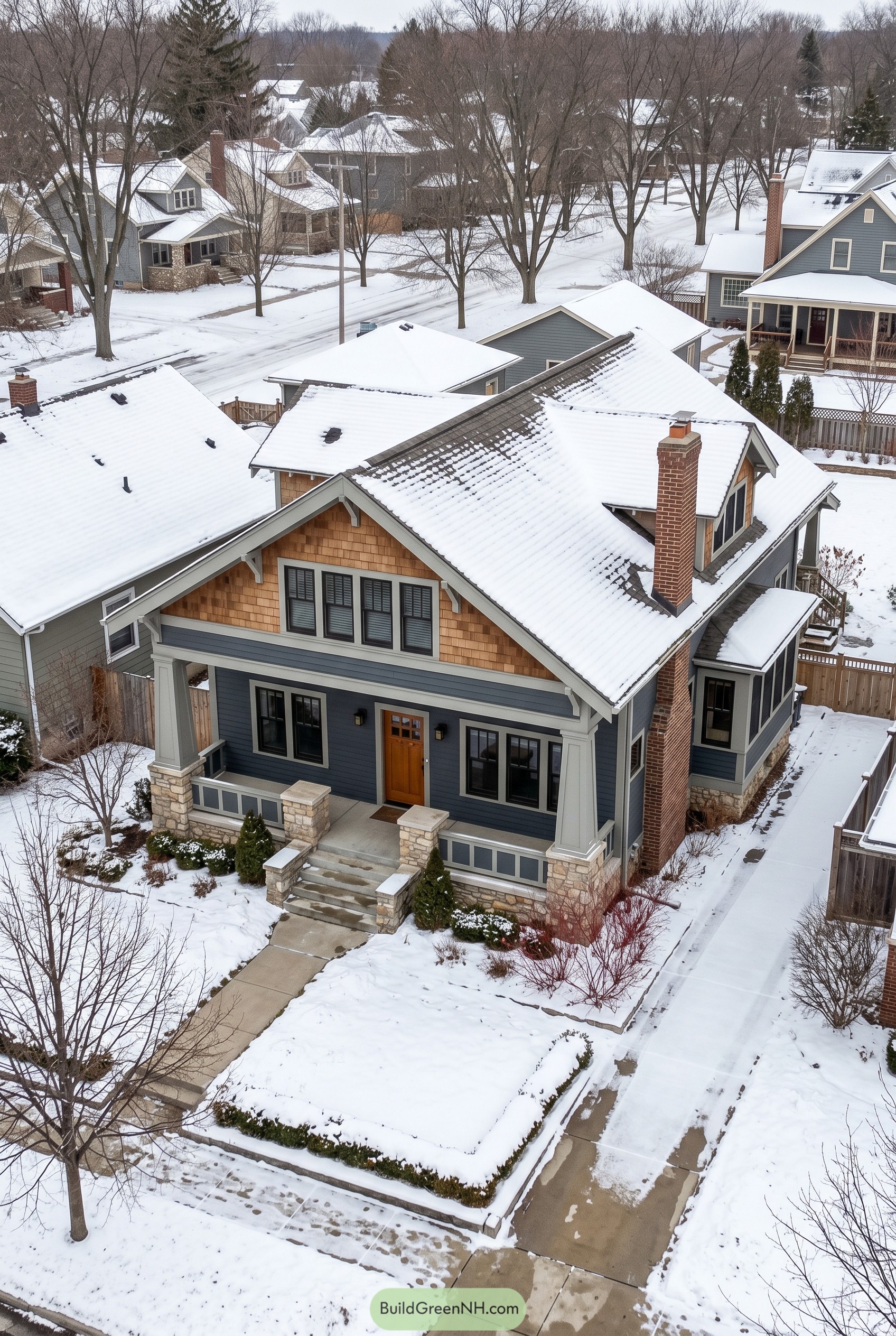 Blue gray Craftsman house with snow covered roof