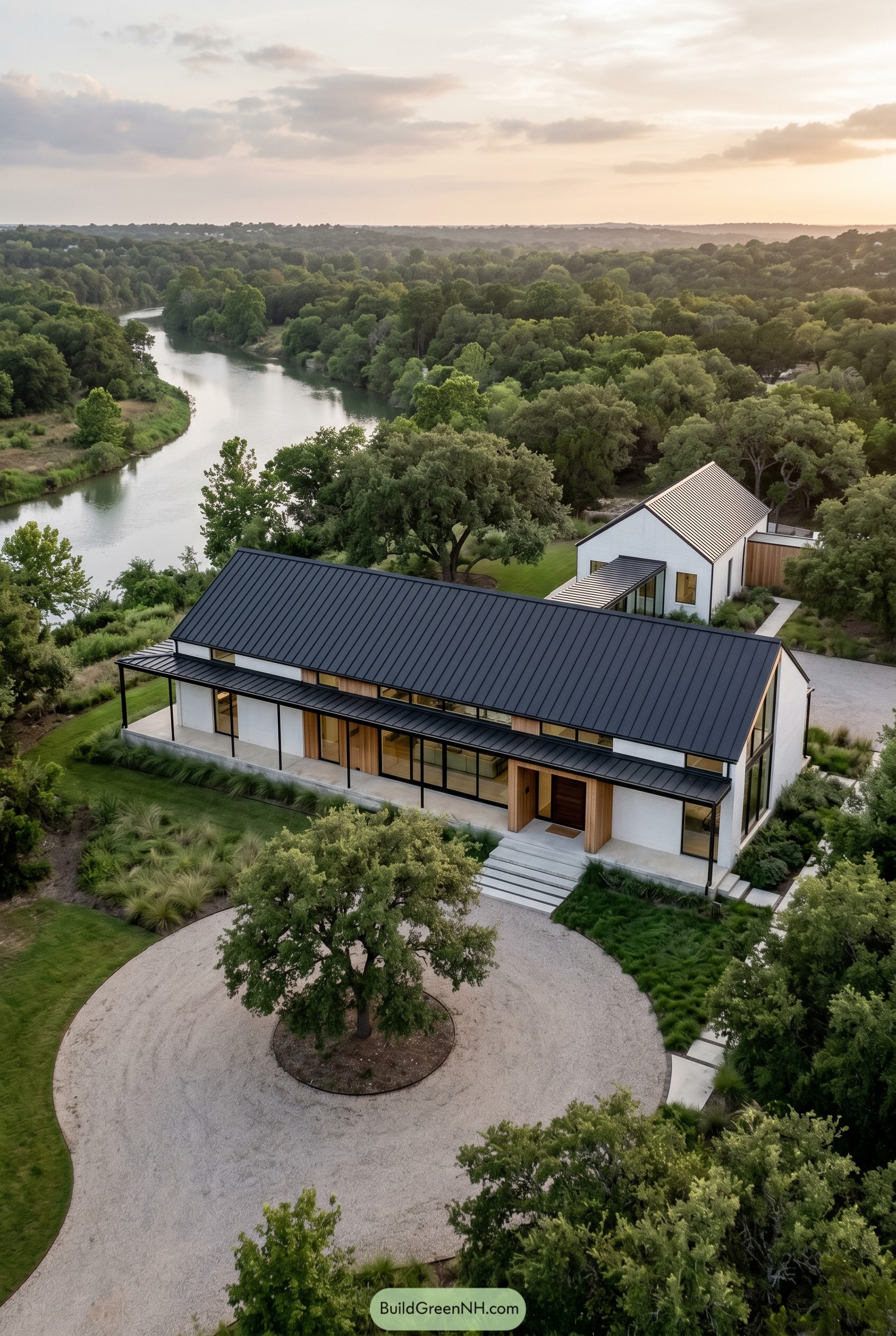 Modern white gabled house beside a winding river
