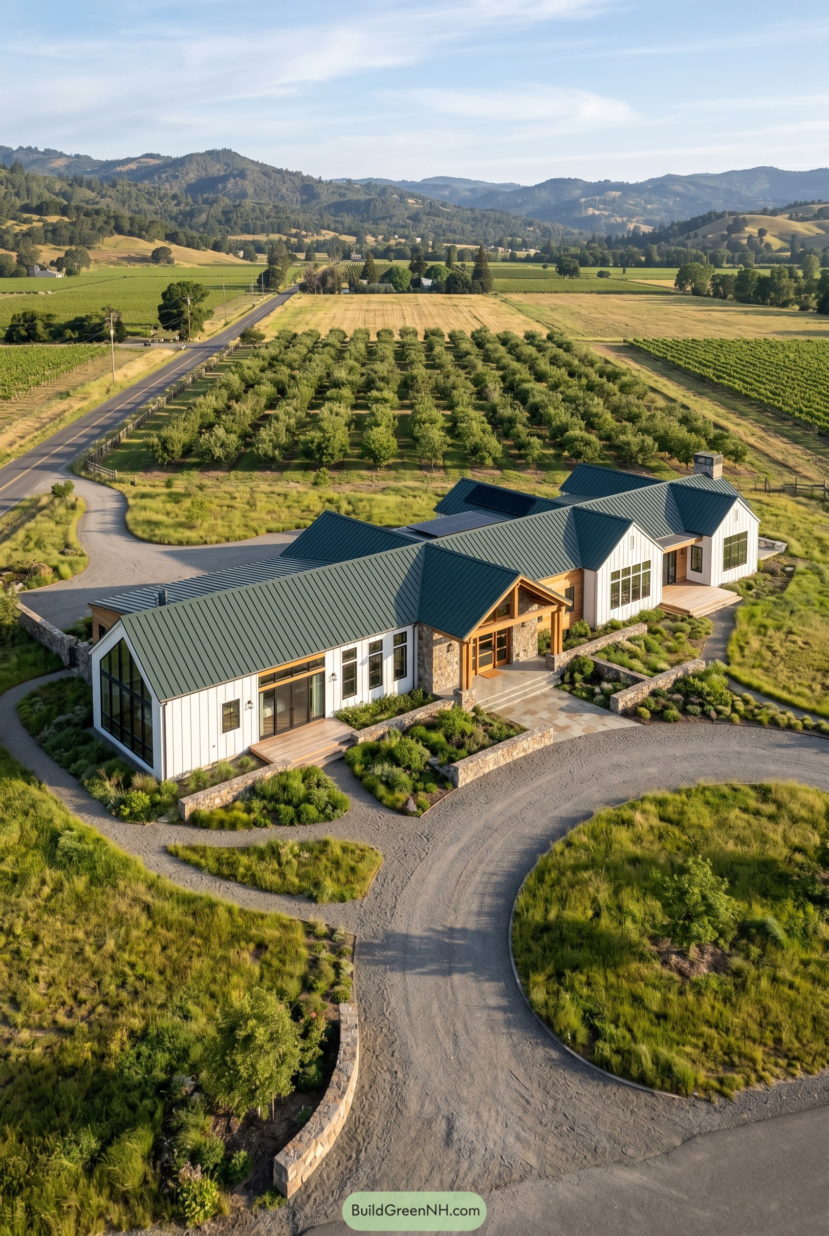 Modern white gabled house beside orchard
