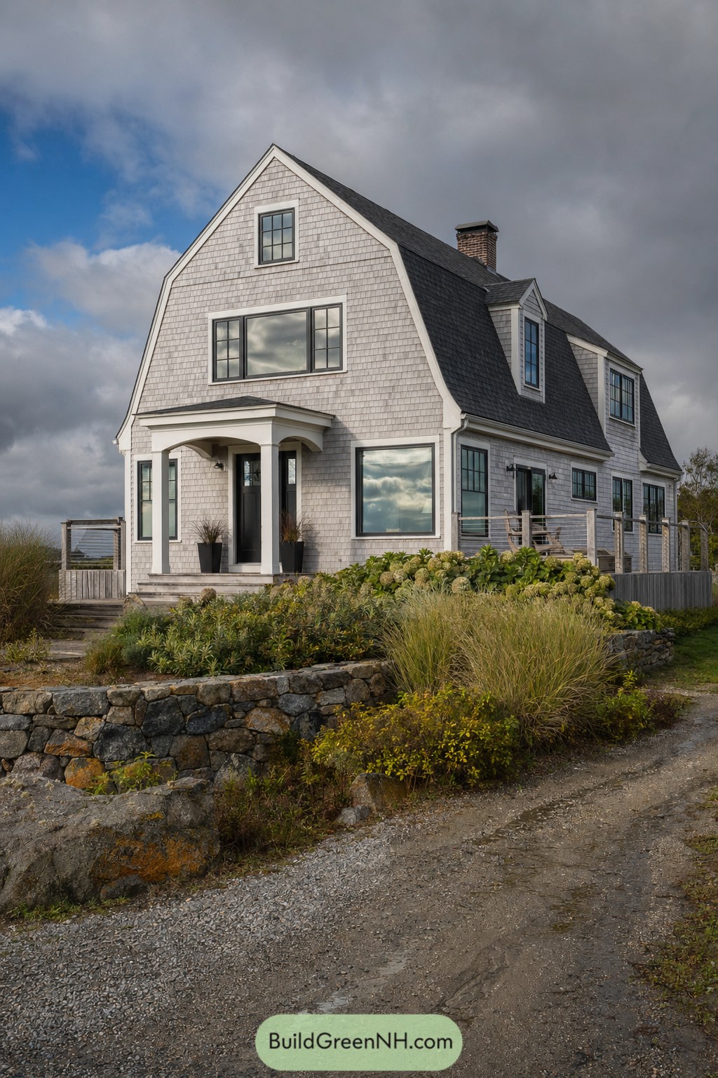 Gray shingle Dutch colonial house with gambrel roof and porch