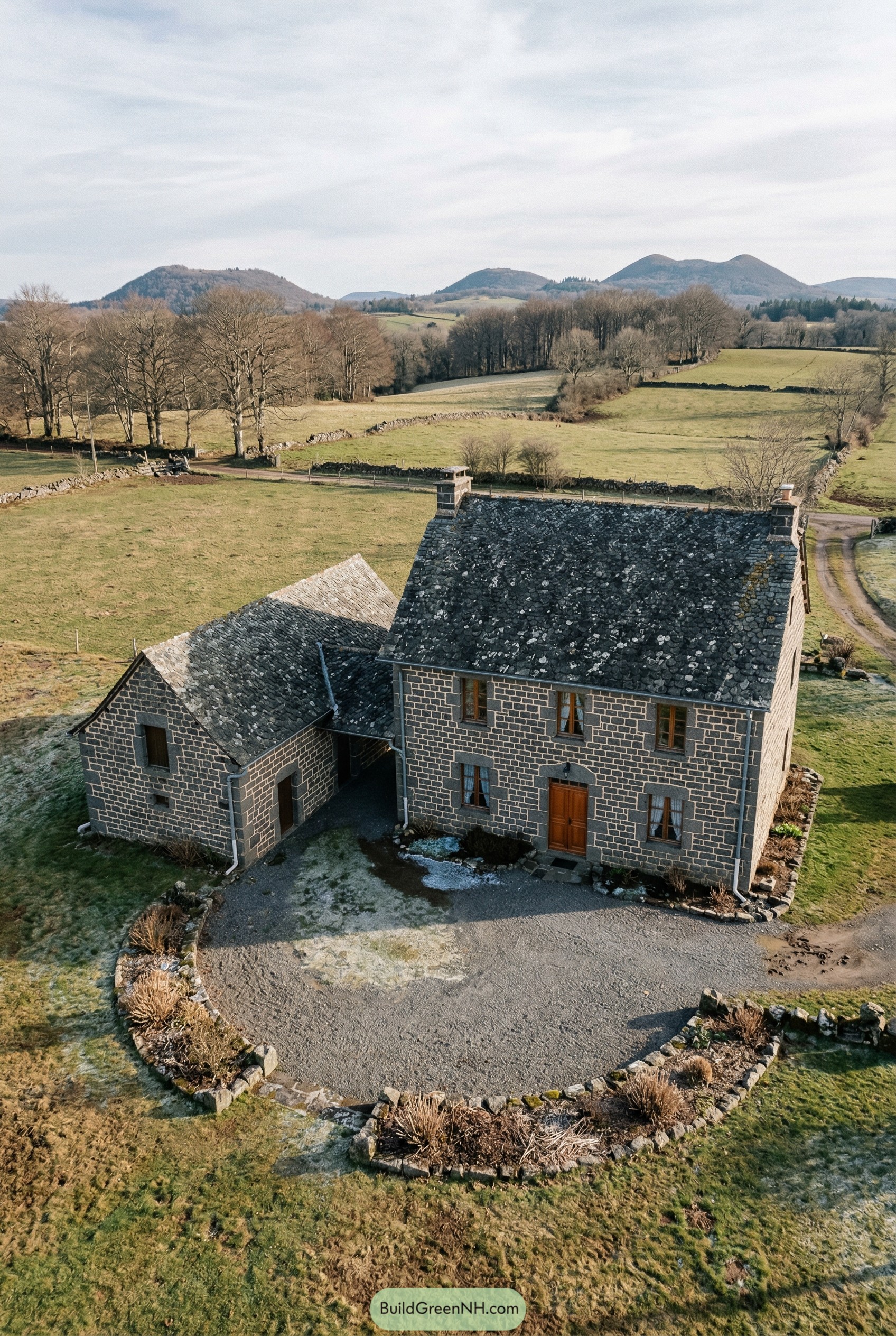 Dark stone farmhouse in open meadows