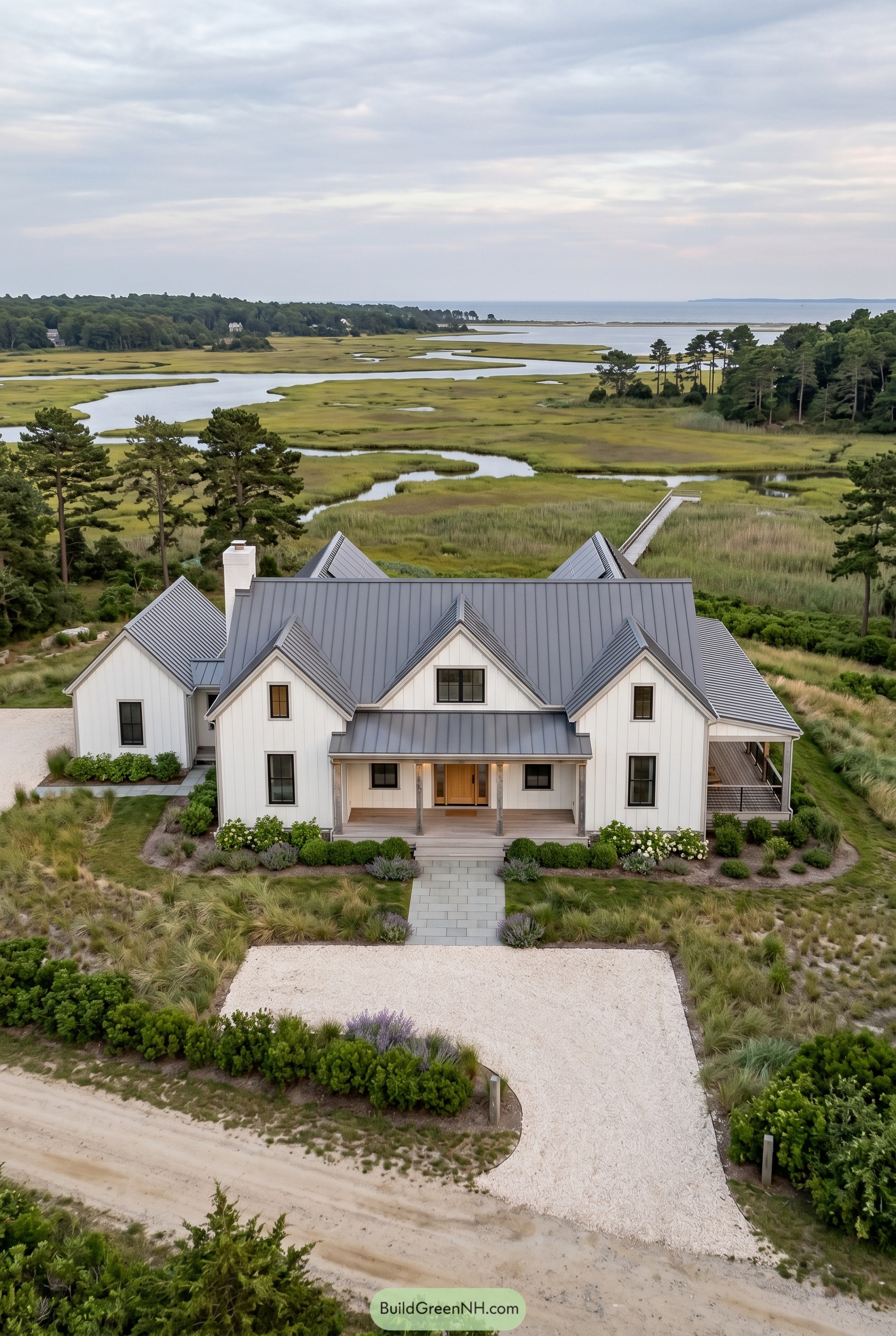 White gabled country home overlooking marshland