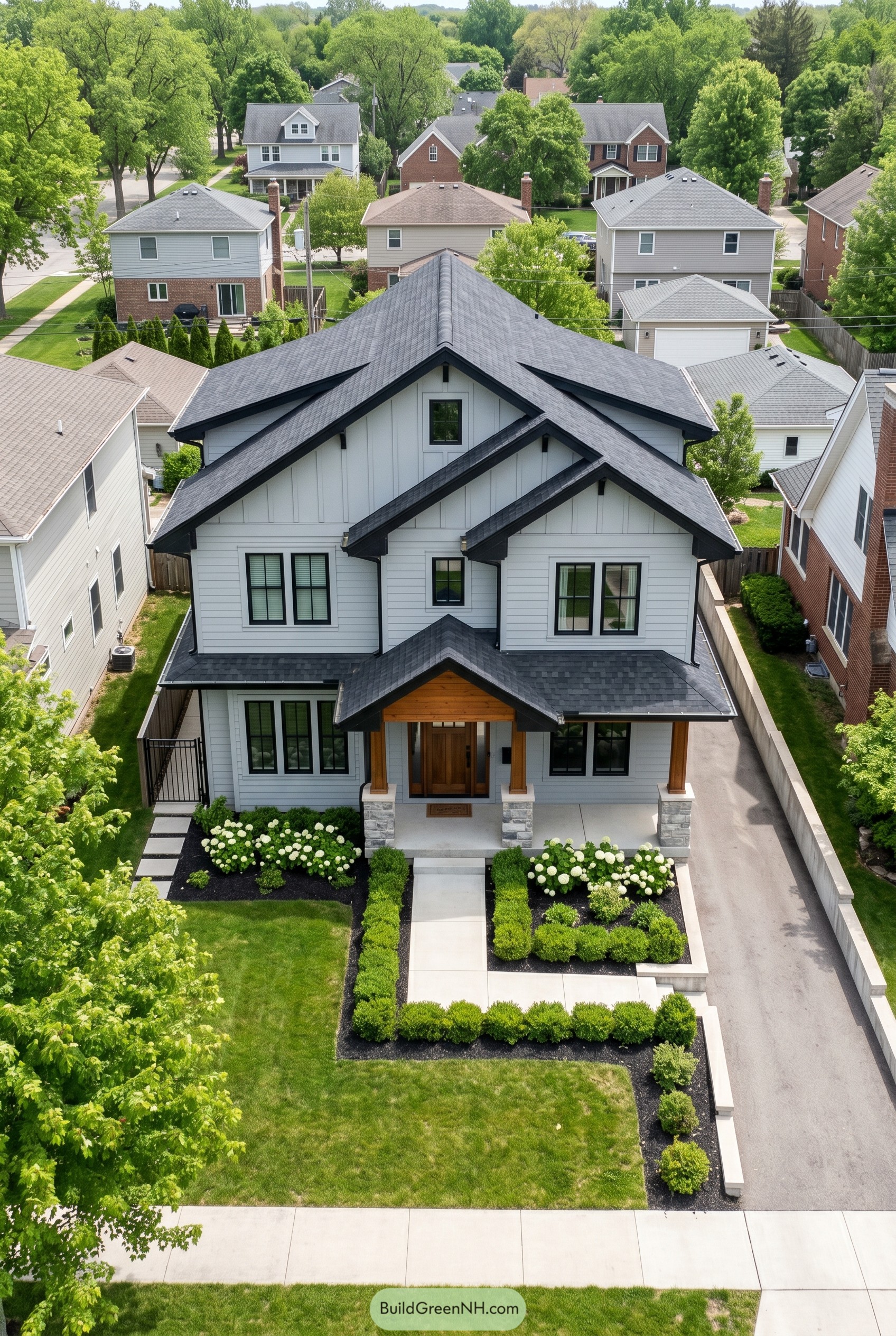 White modern craftsman home with layered black gables