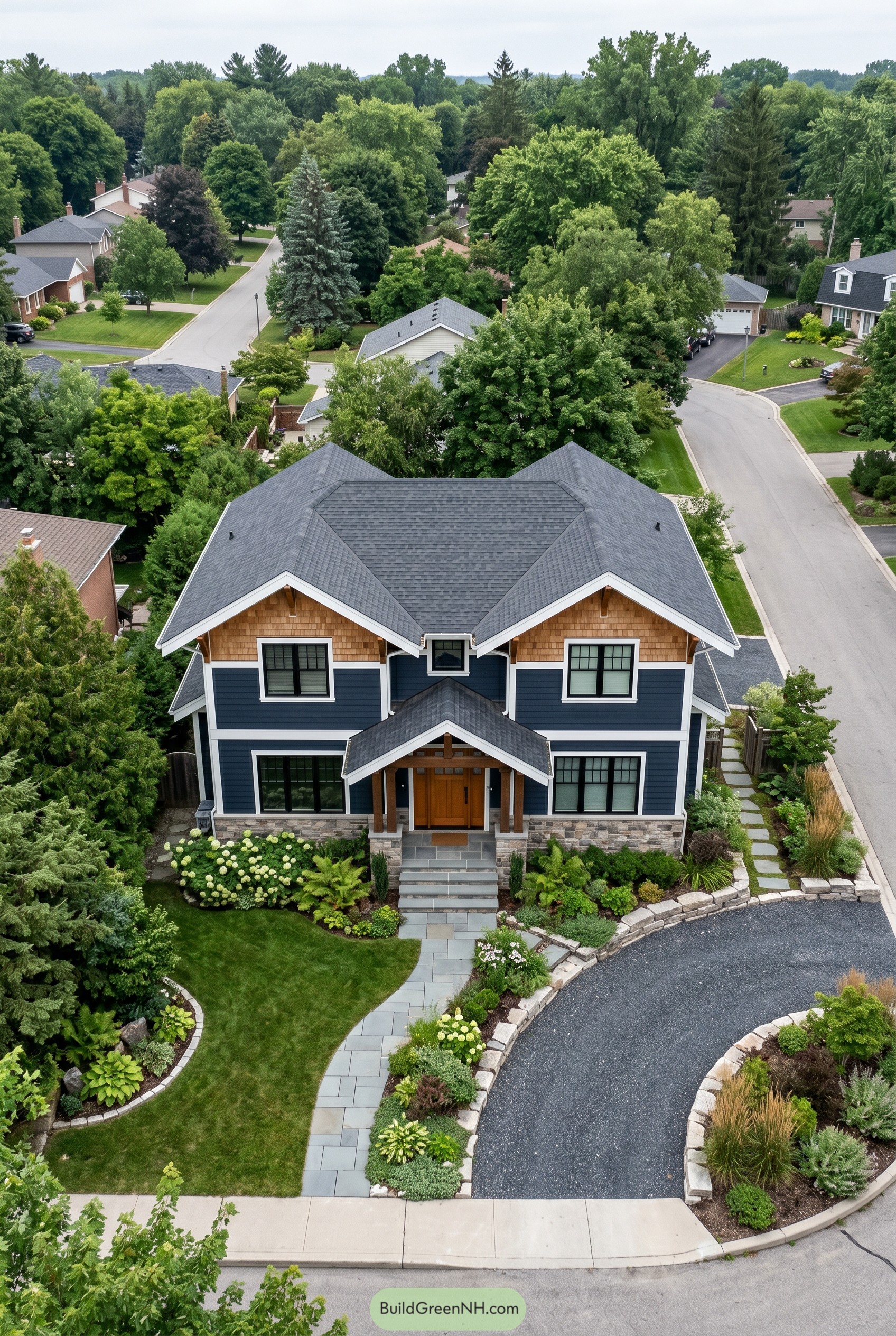 Blue modern craftsman house with twin gables and curved driveway