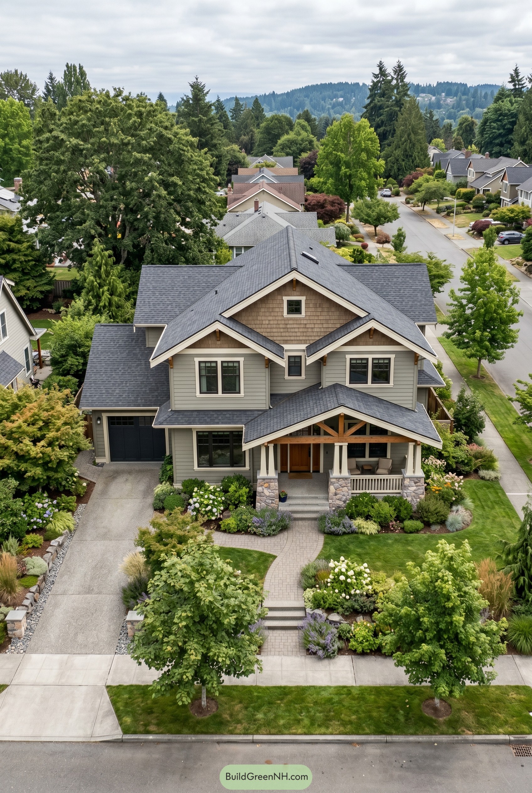 Gray modern craftsman house with layered gables and stone porch