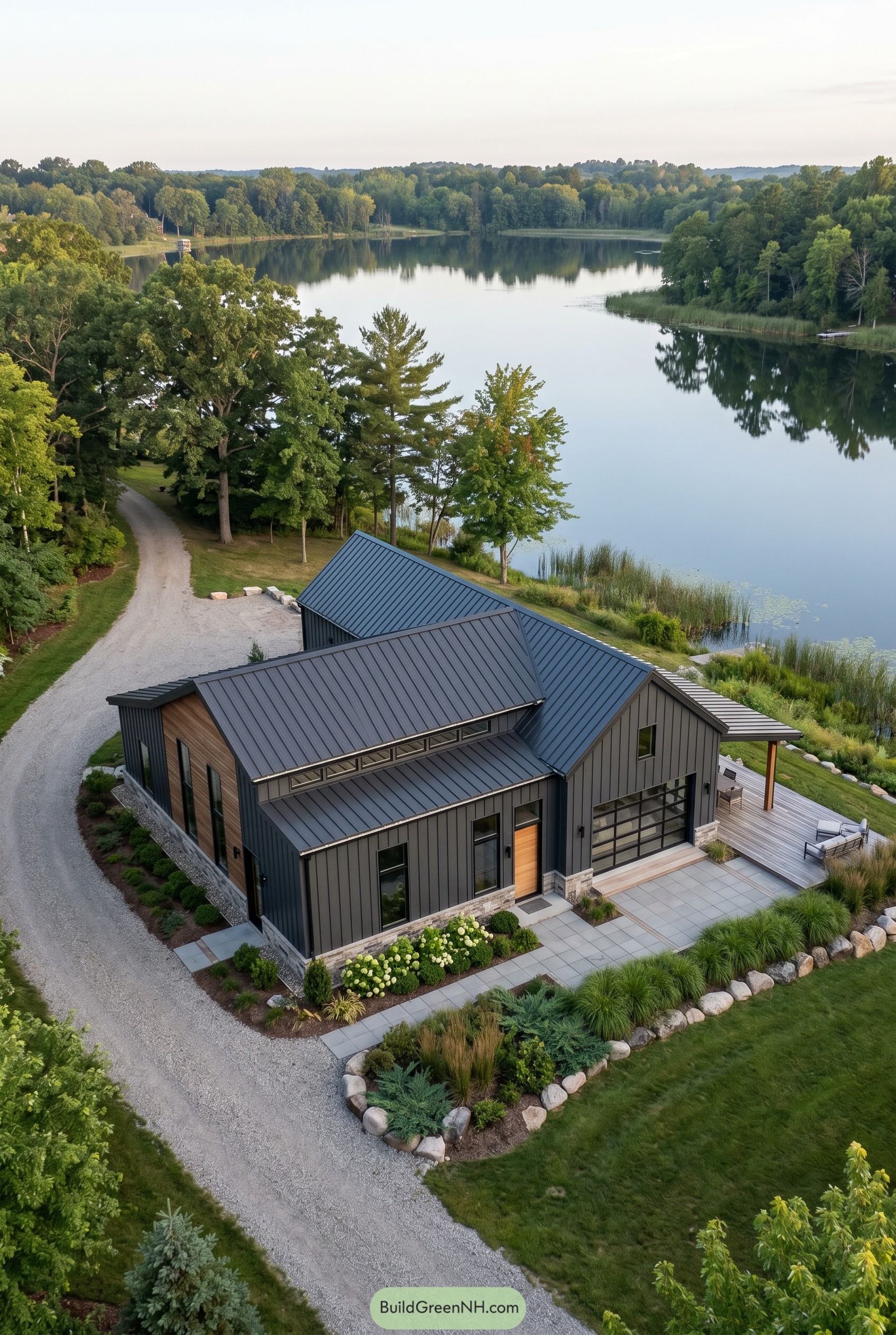 Modern lakeside barndominium with dark metal roof