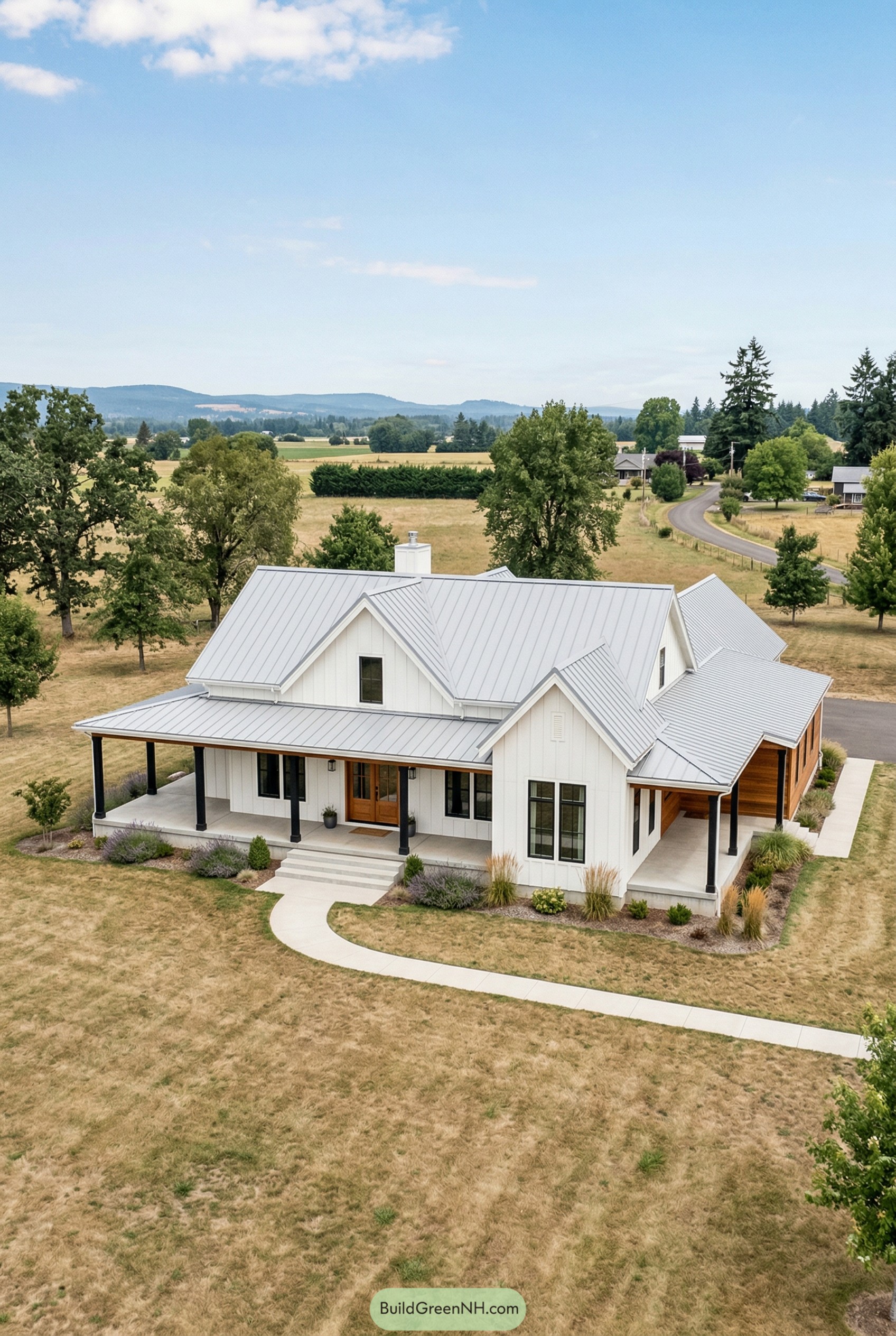 White house with metal roof and wraparound porch