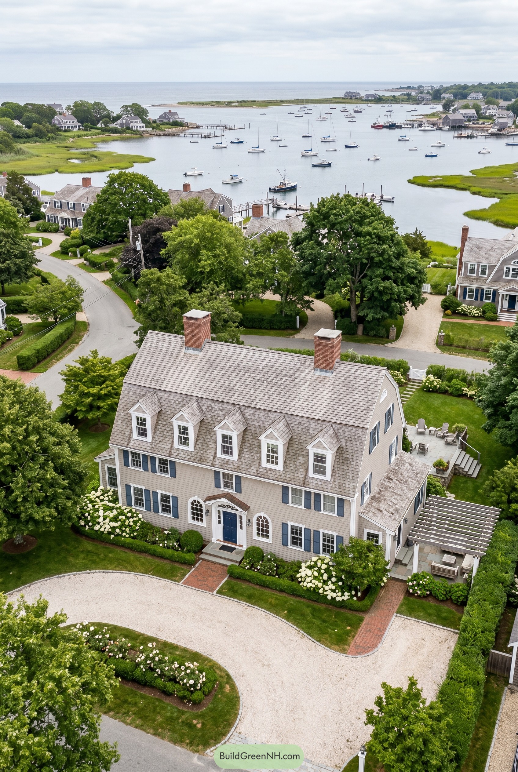 Large shingle gambrel house overlooking a harbor