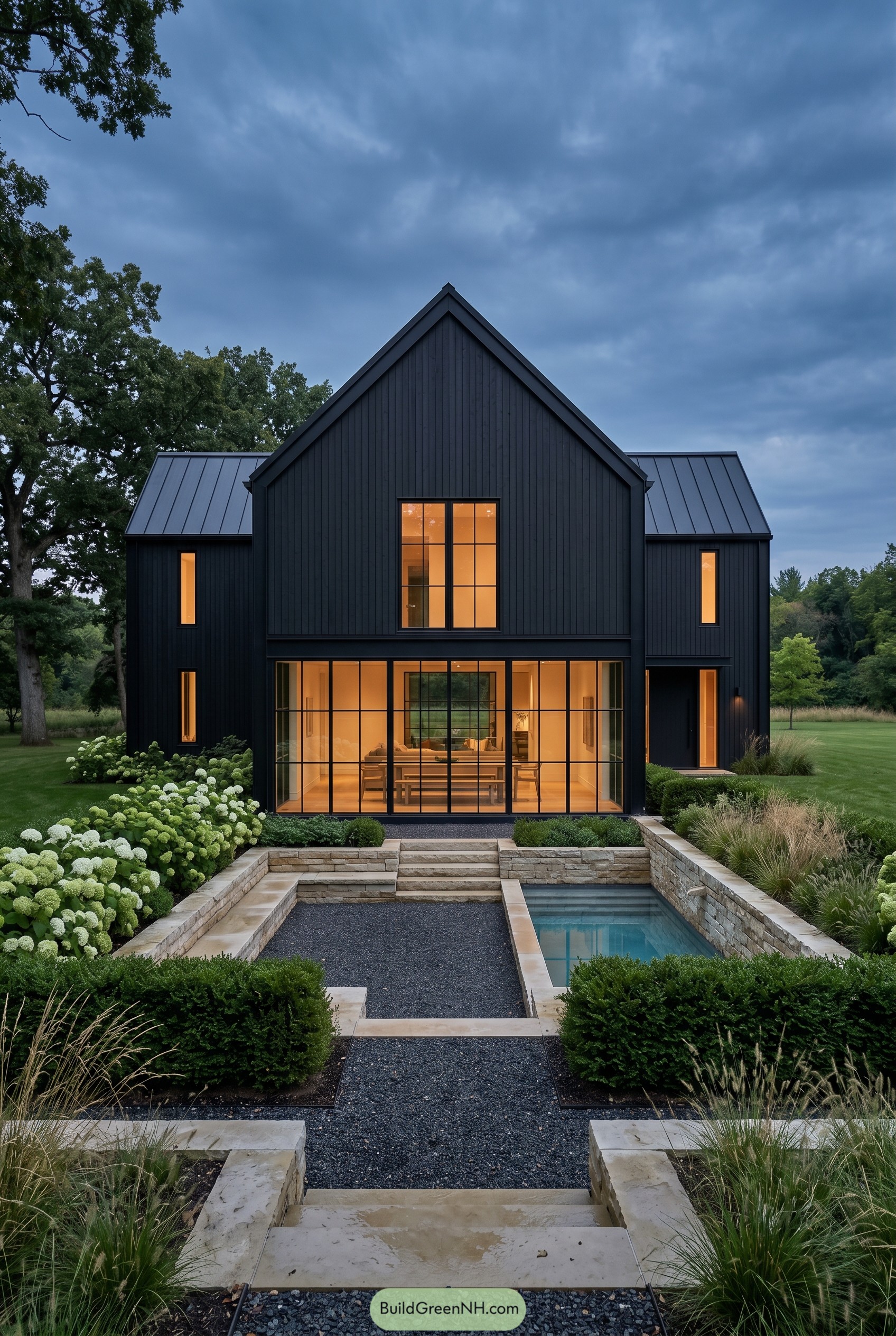 Black barnhouse with central glass sunroom and stone courtyard pool