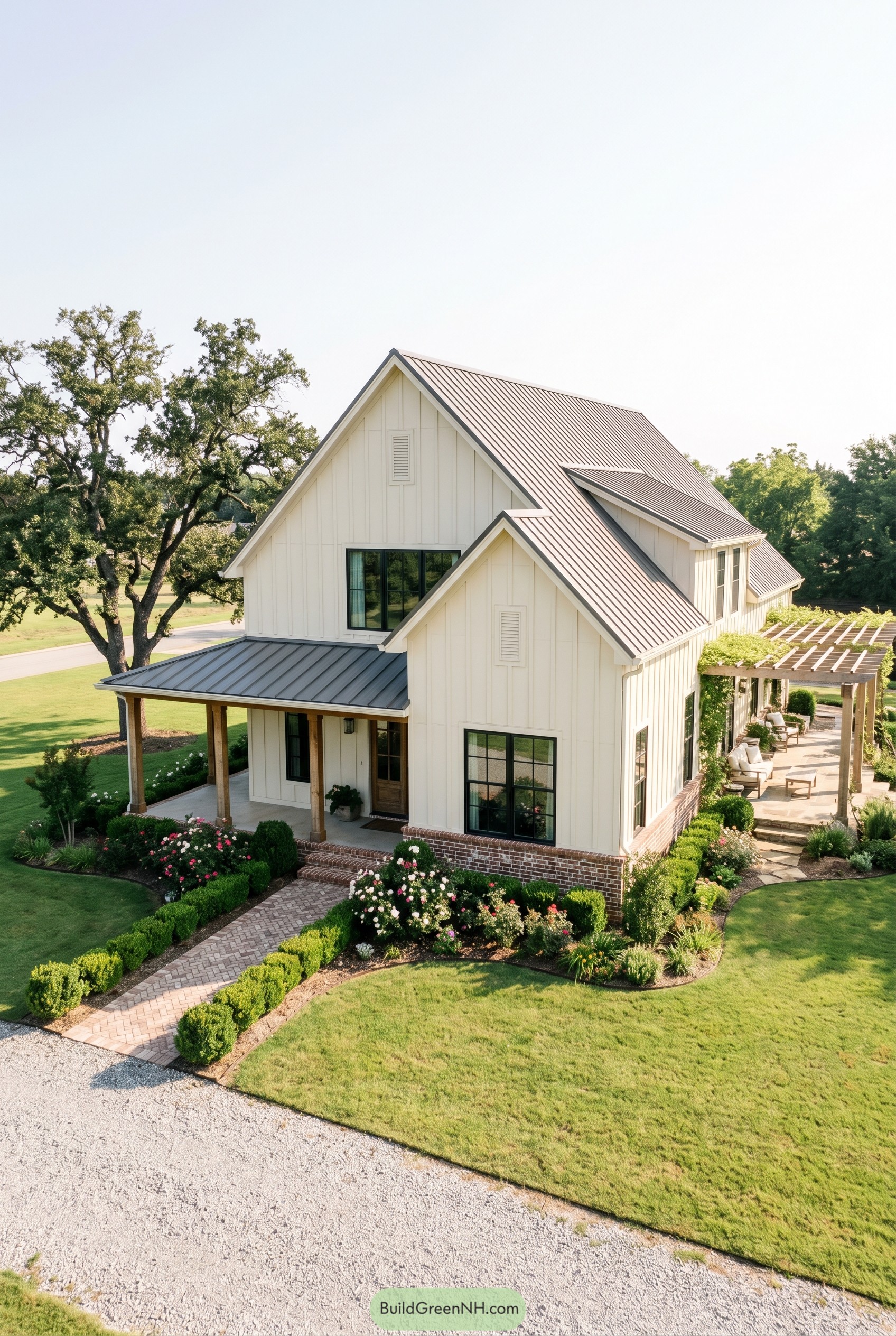 White cottage barndominium with metal roof and pergola