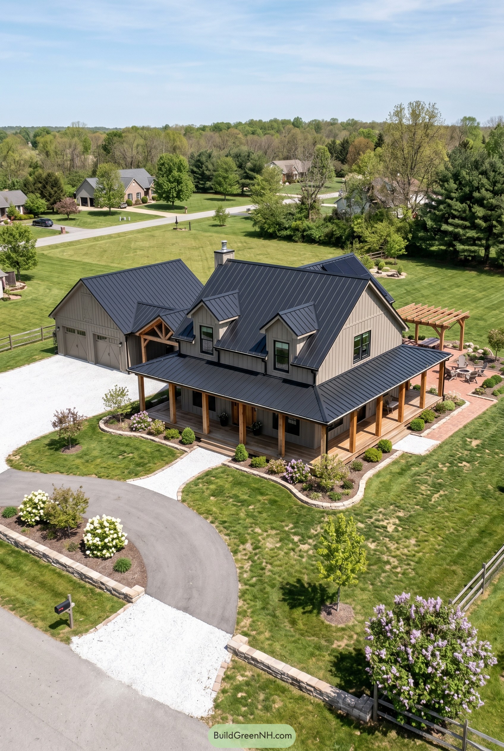 Gray cottage barndominium with black roof and wraparound porch