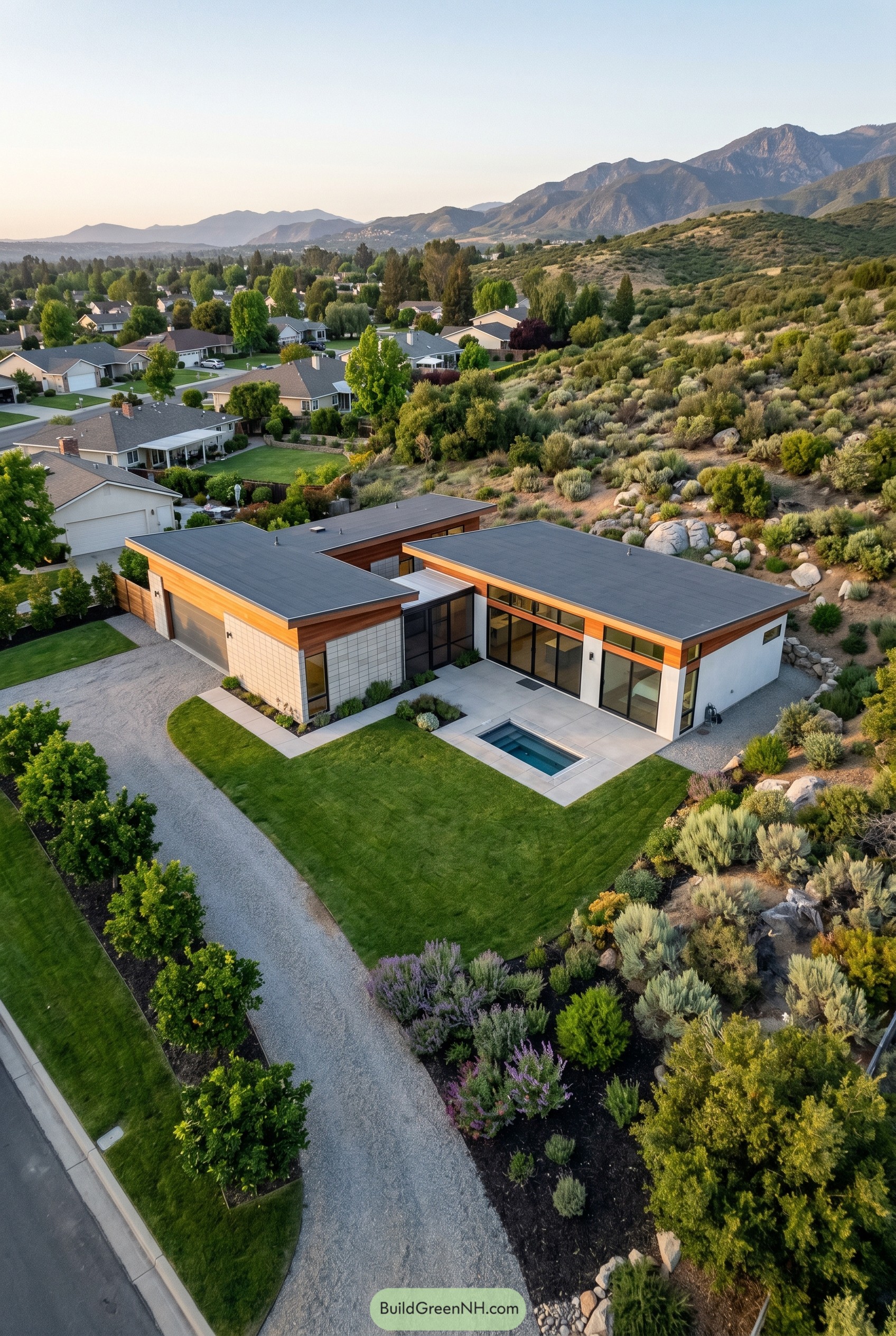 Aerial view of a modern ranch house with breeze block walls and a small pool