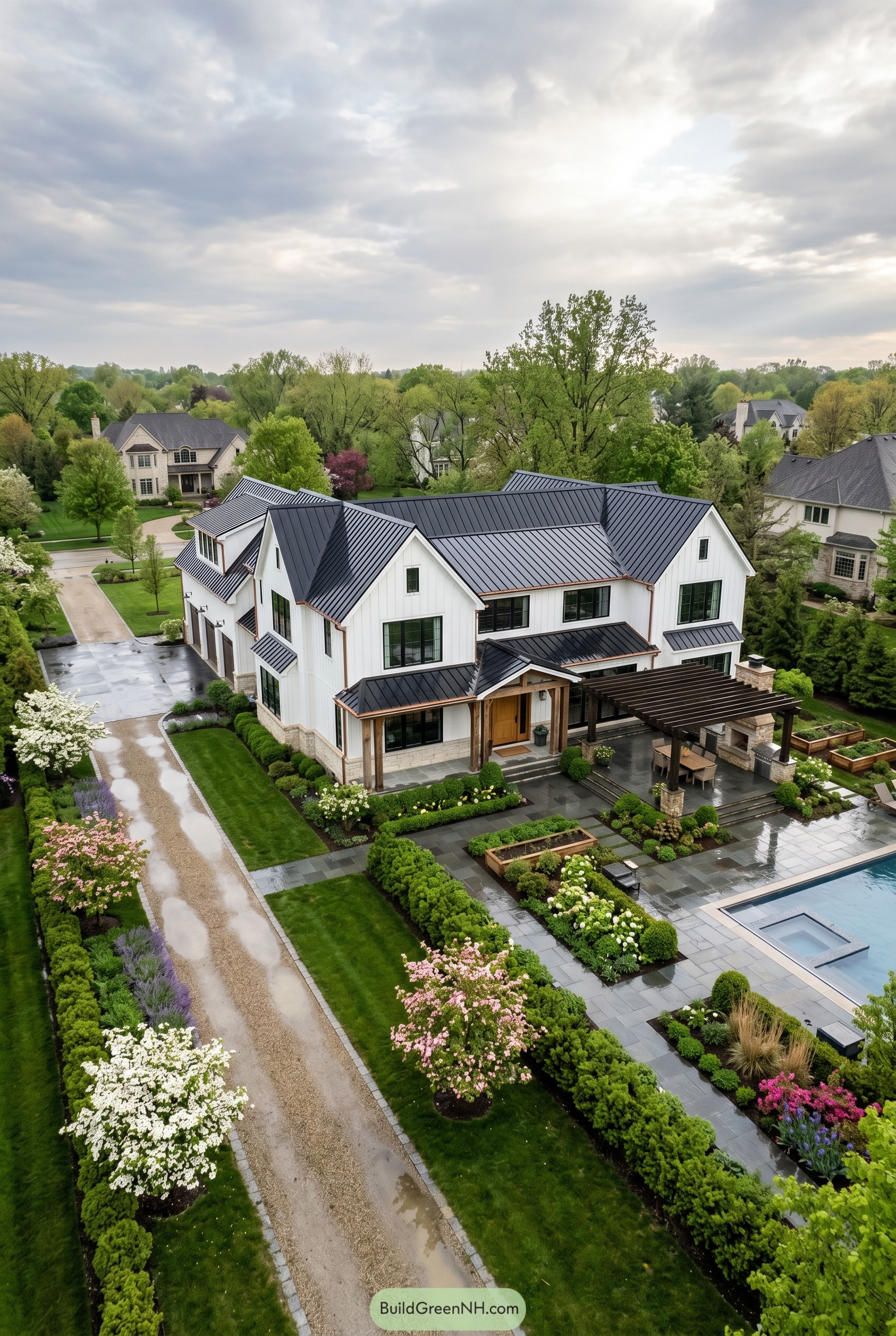 White modern farmhouse mansion with black metal roof and pool terrace