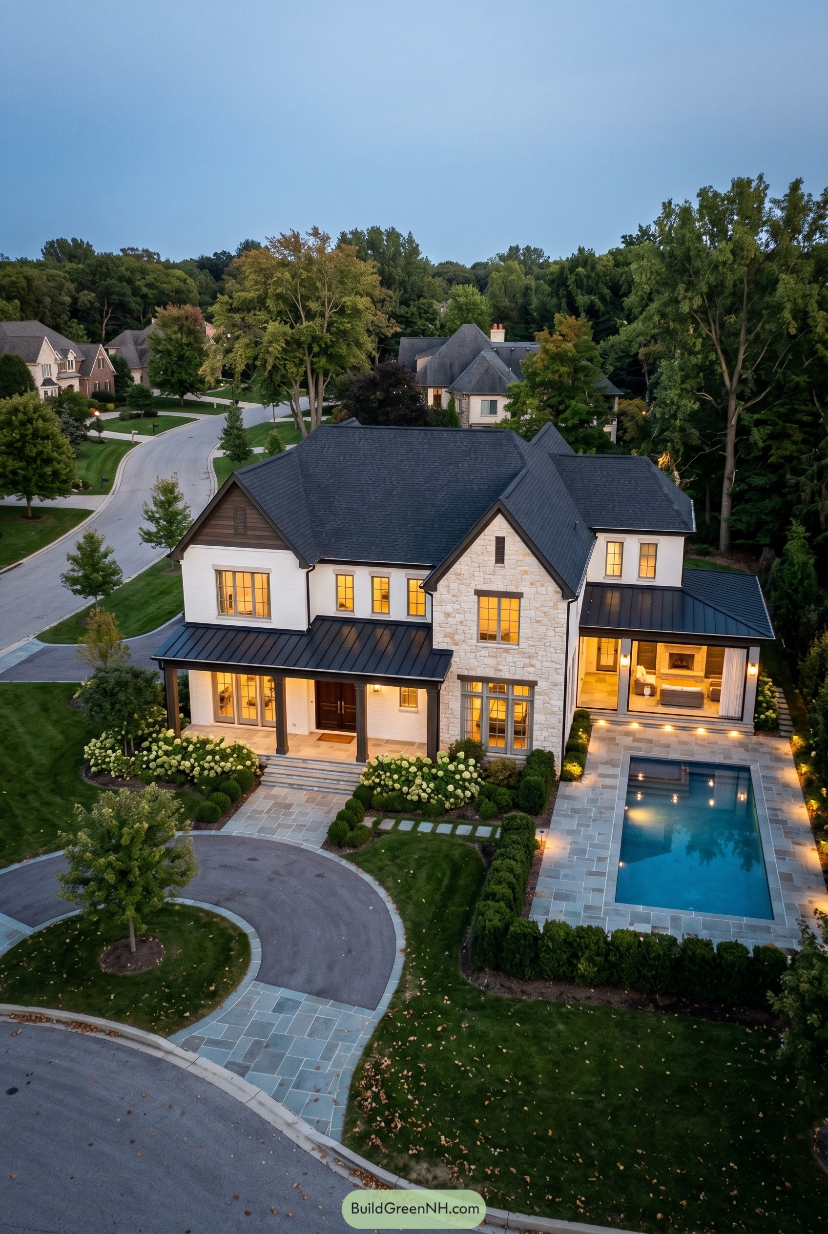 Two story stone and white brick mansion with pool