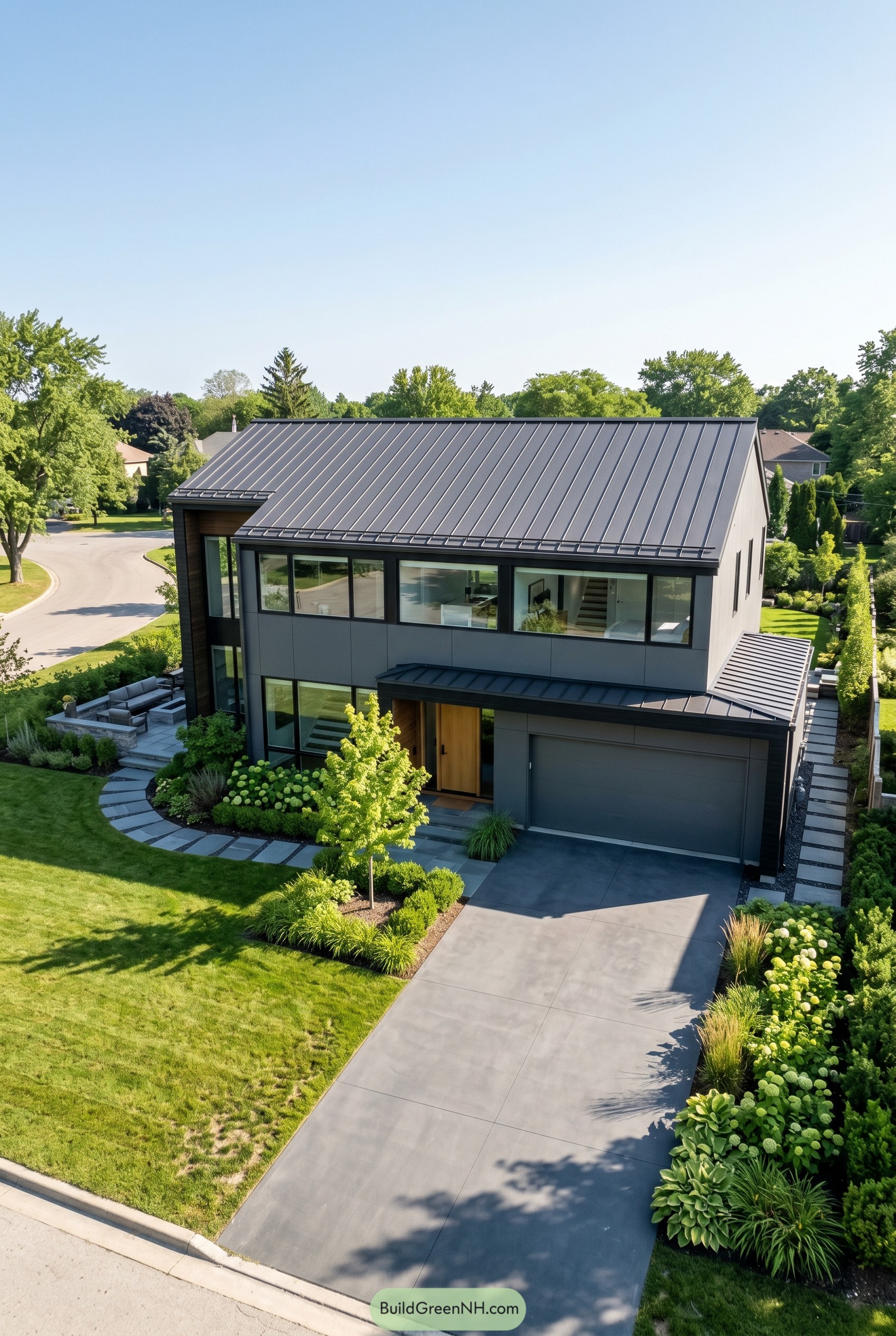 Charcoal modern house with gabled metal roof and wood entry