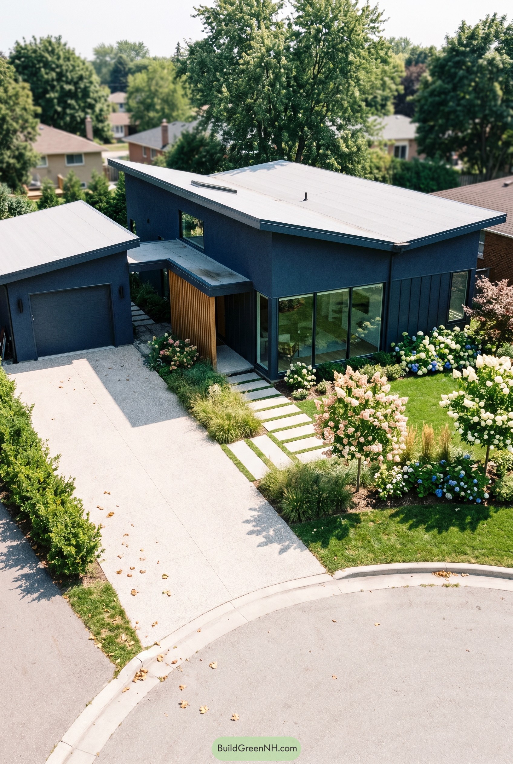 Deep navy modern house with angled roofs and lush garden