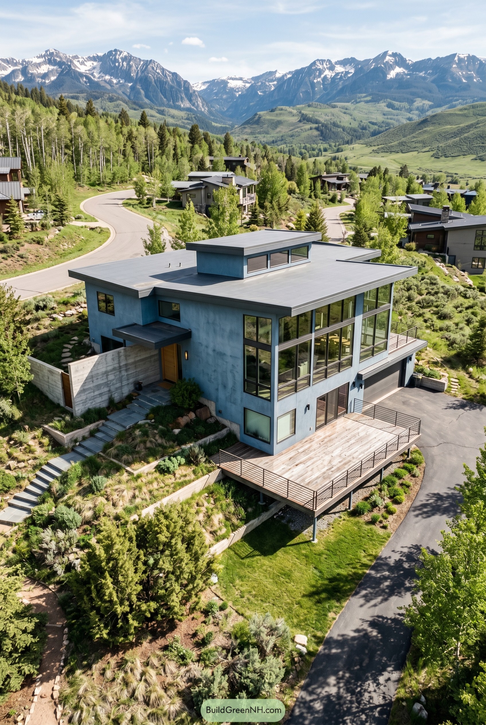 Dusty blue modern hillside house with mountain views