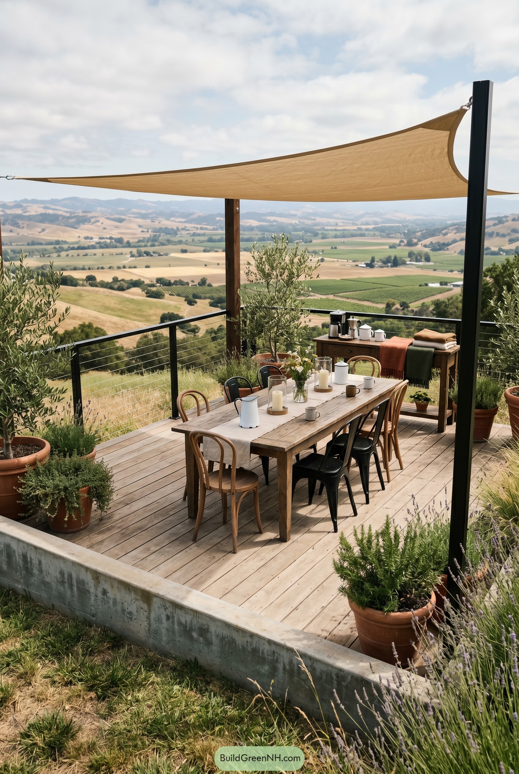 Rustic deck dining area with shade sail and valley view