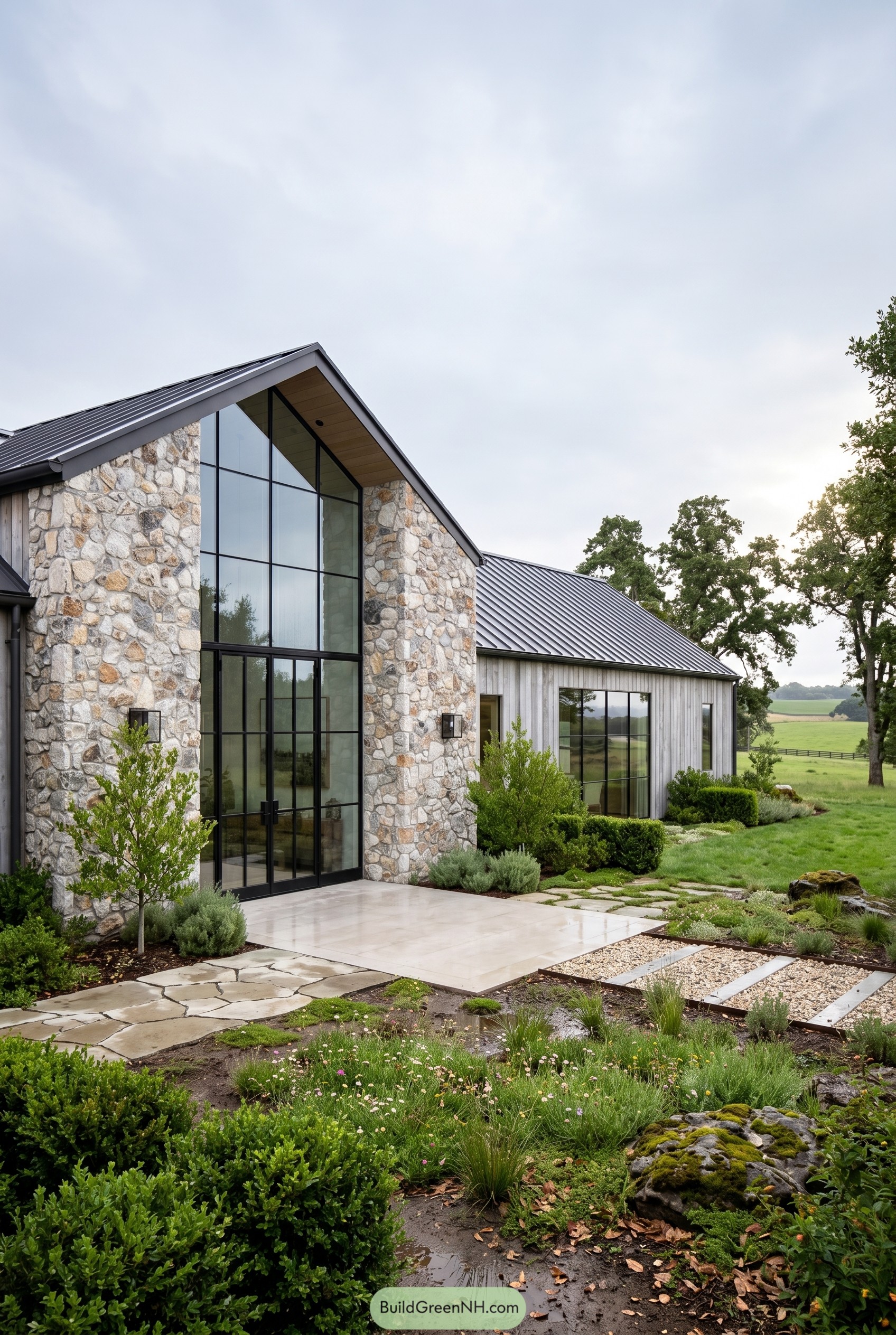 Stone farmhouse with tall glass gable entry