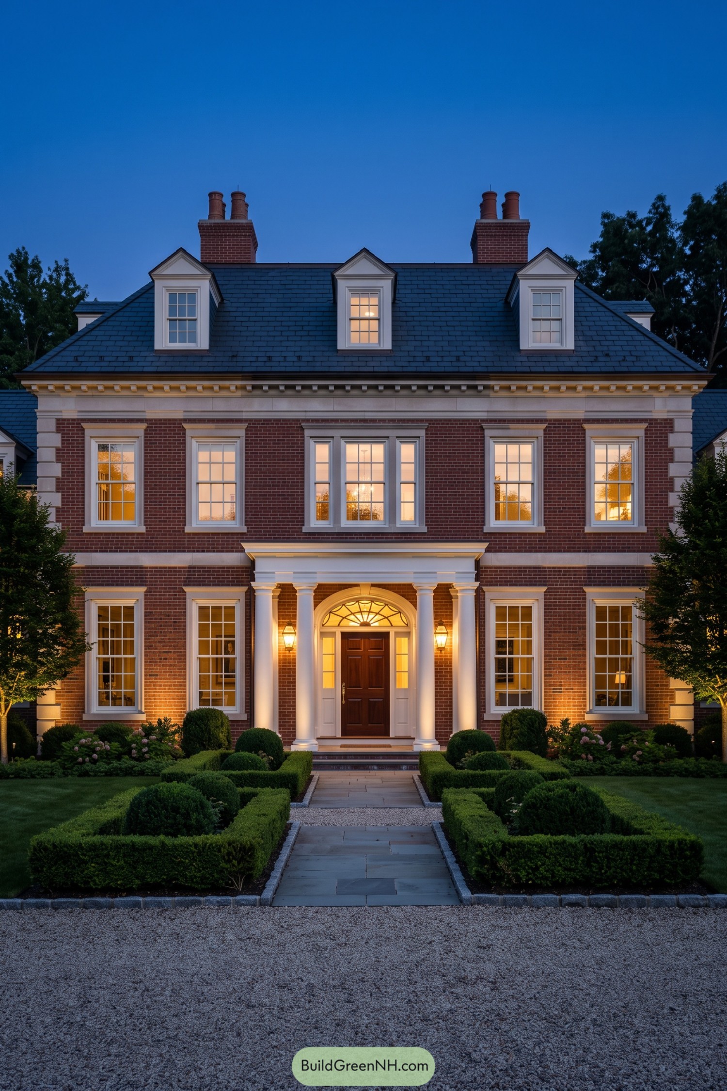 Red brick Federal home with a columned entry and dormers