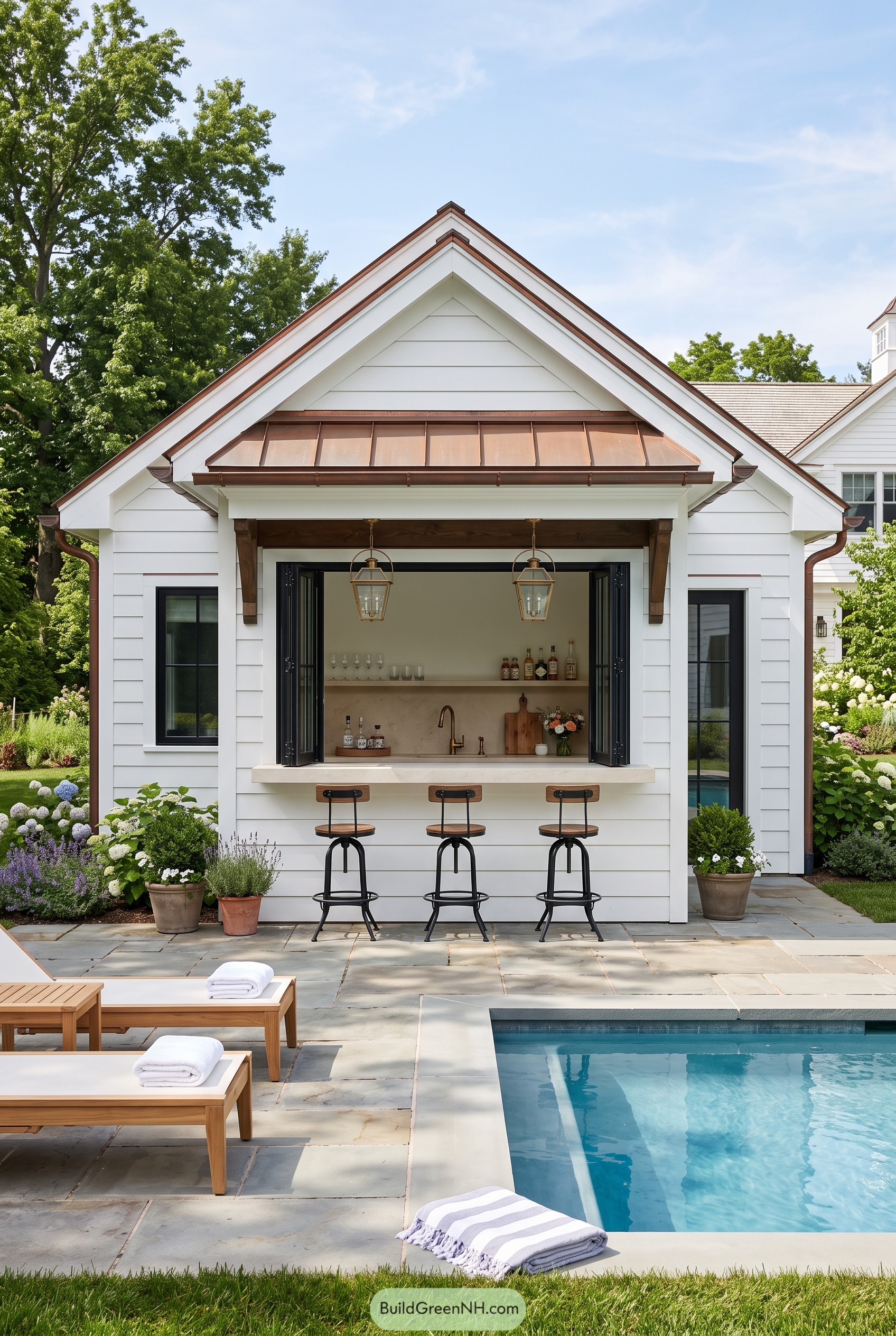 White pool house with copper awning and bar seating
