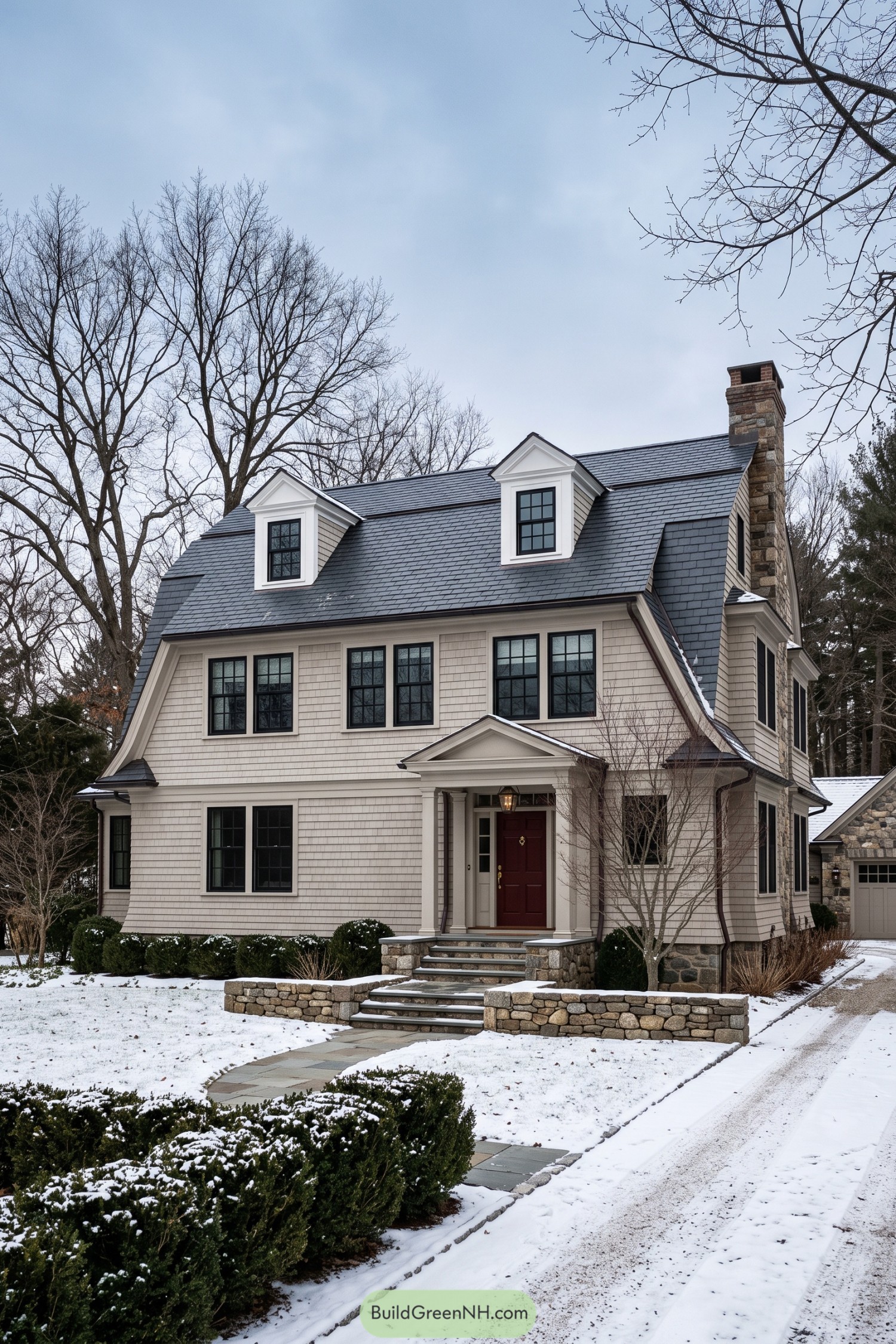 Cream shingle home with slate roof dormers and stone chimney