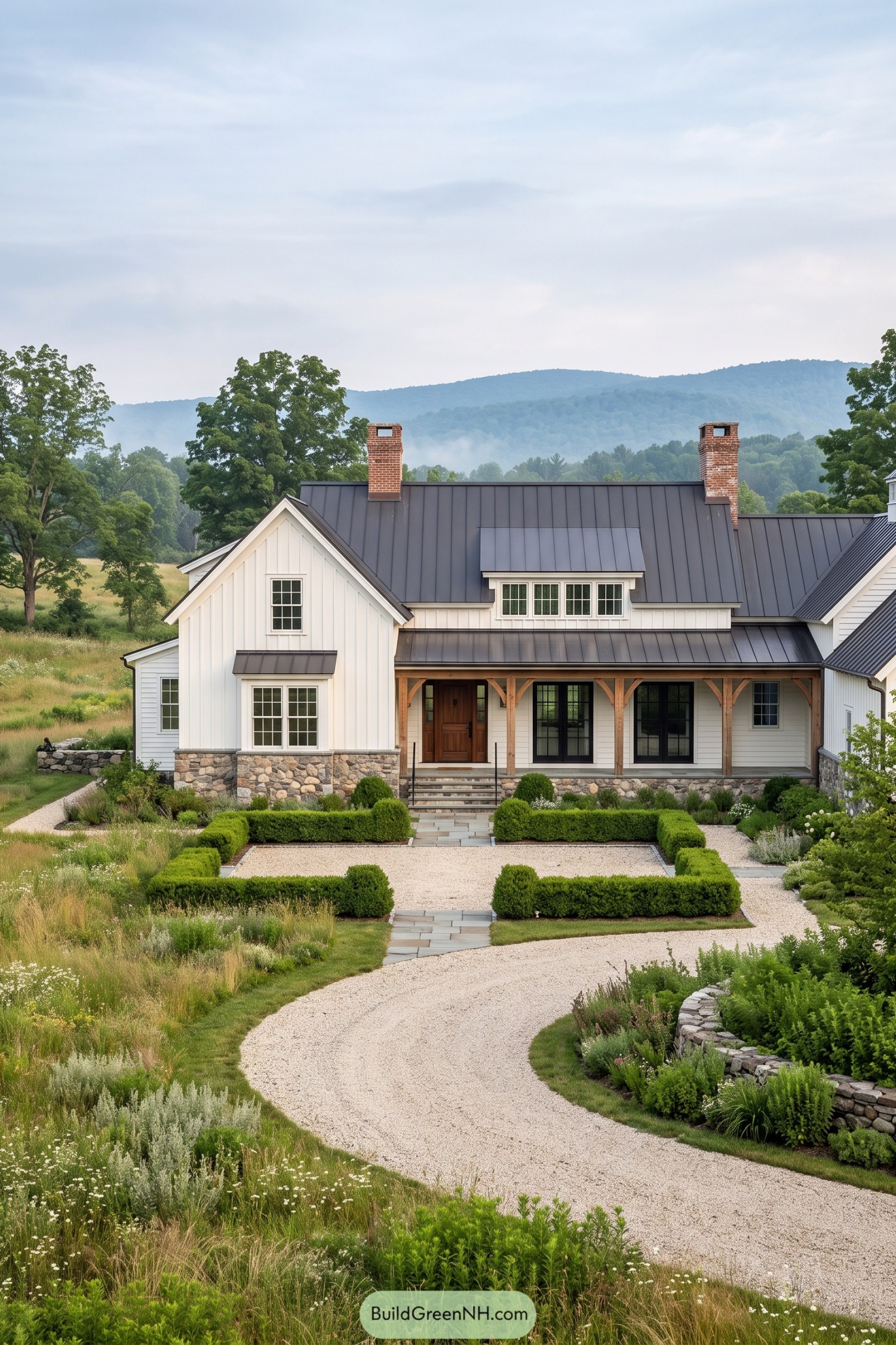 White board-and-batten farmhouse with dark metal roof and stone foundation
