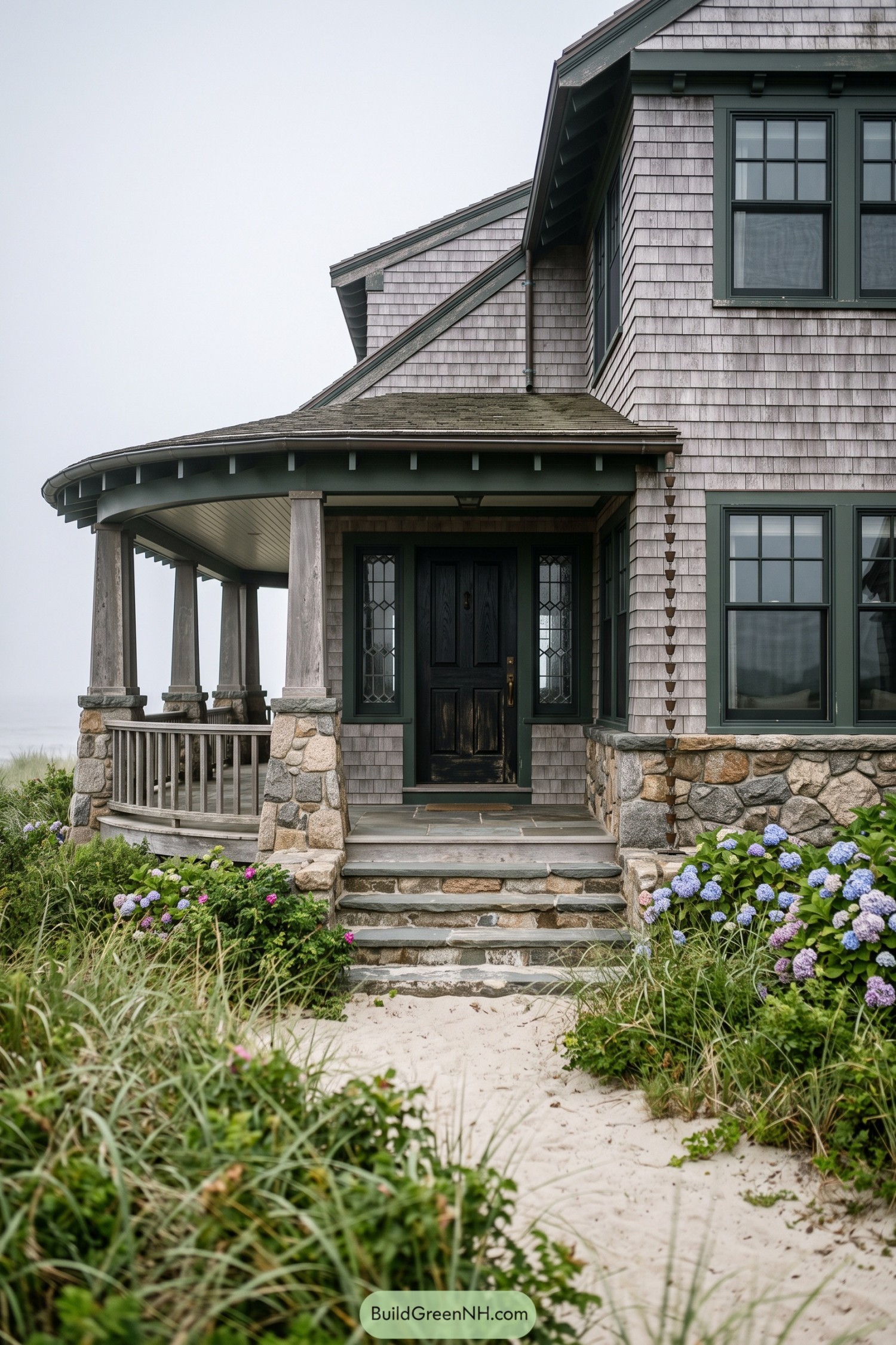 Curved porch entrance with cedar shingles and fieldstone columns