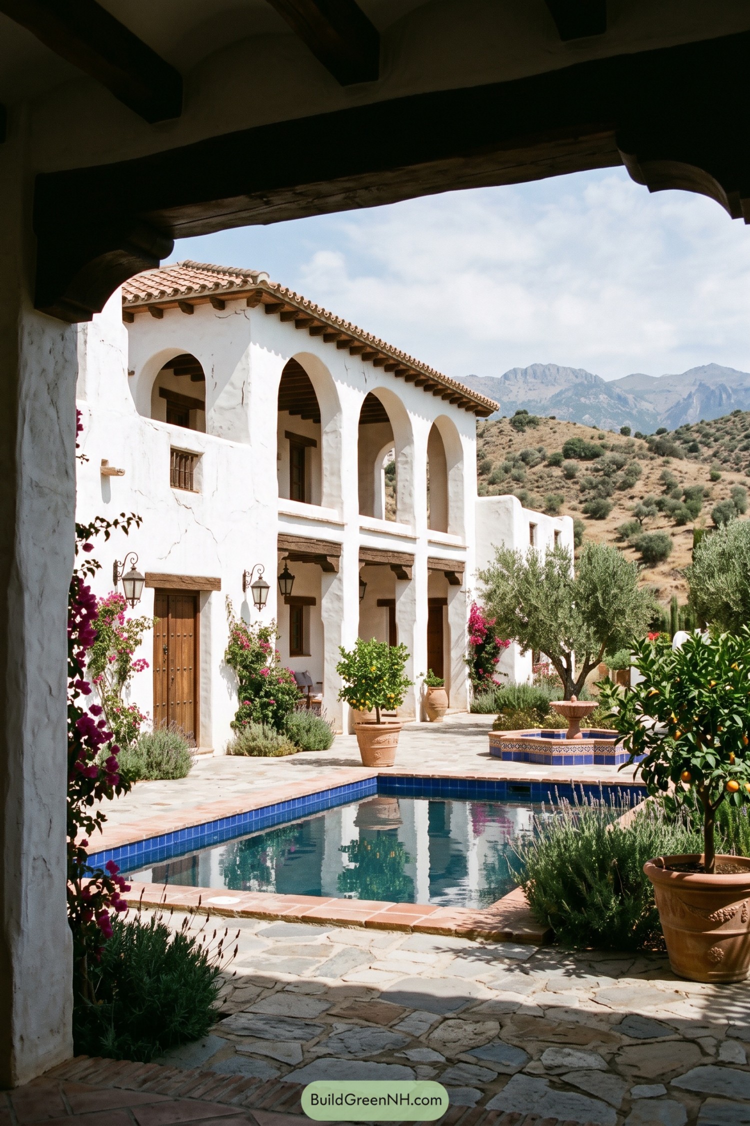 White stucco hacienda with arched loggia and blue pool