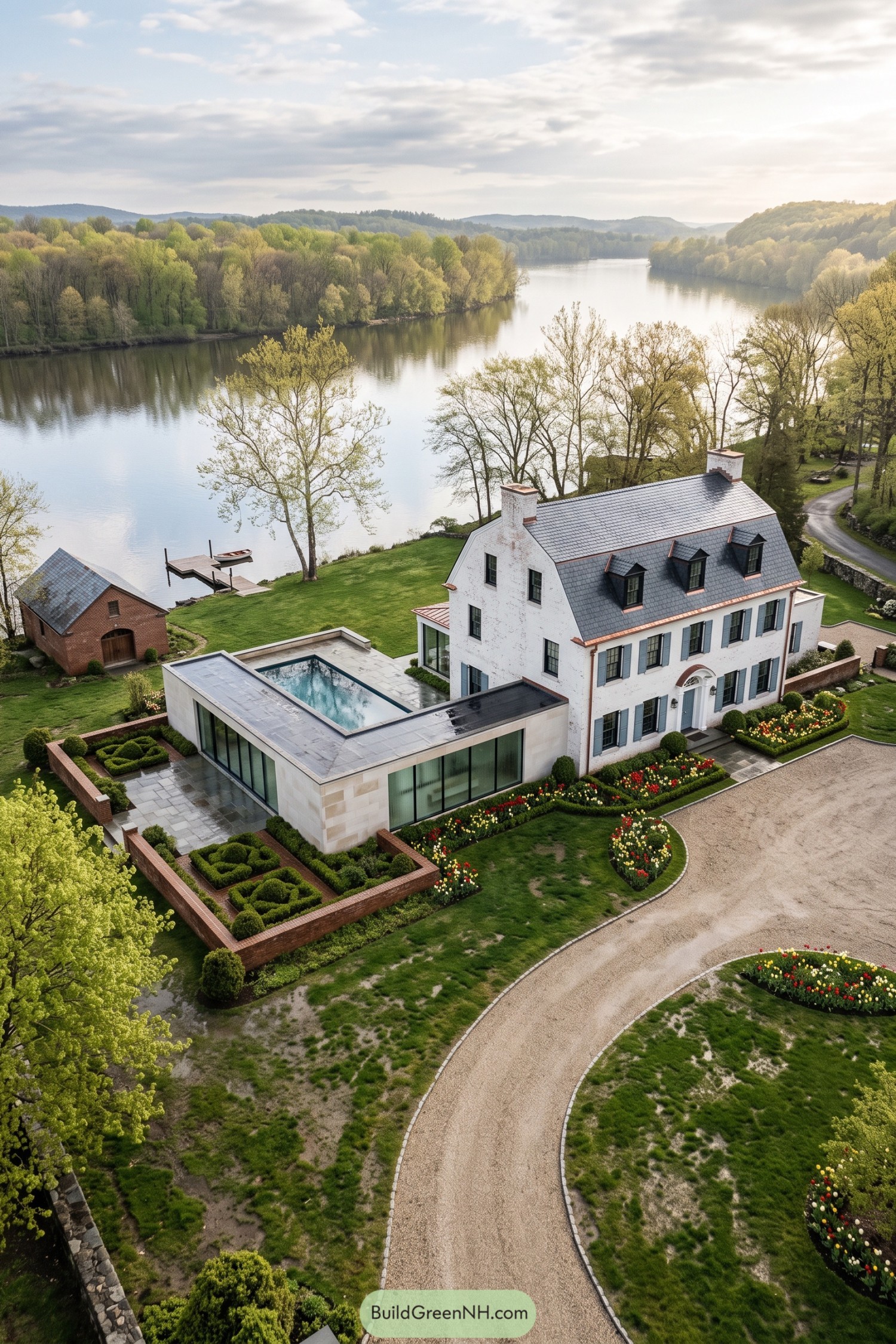 White brick Federal house with a modern pool wing beside the river