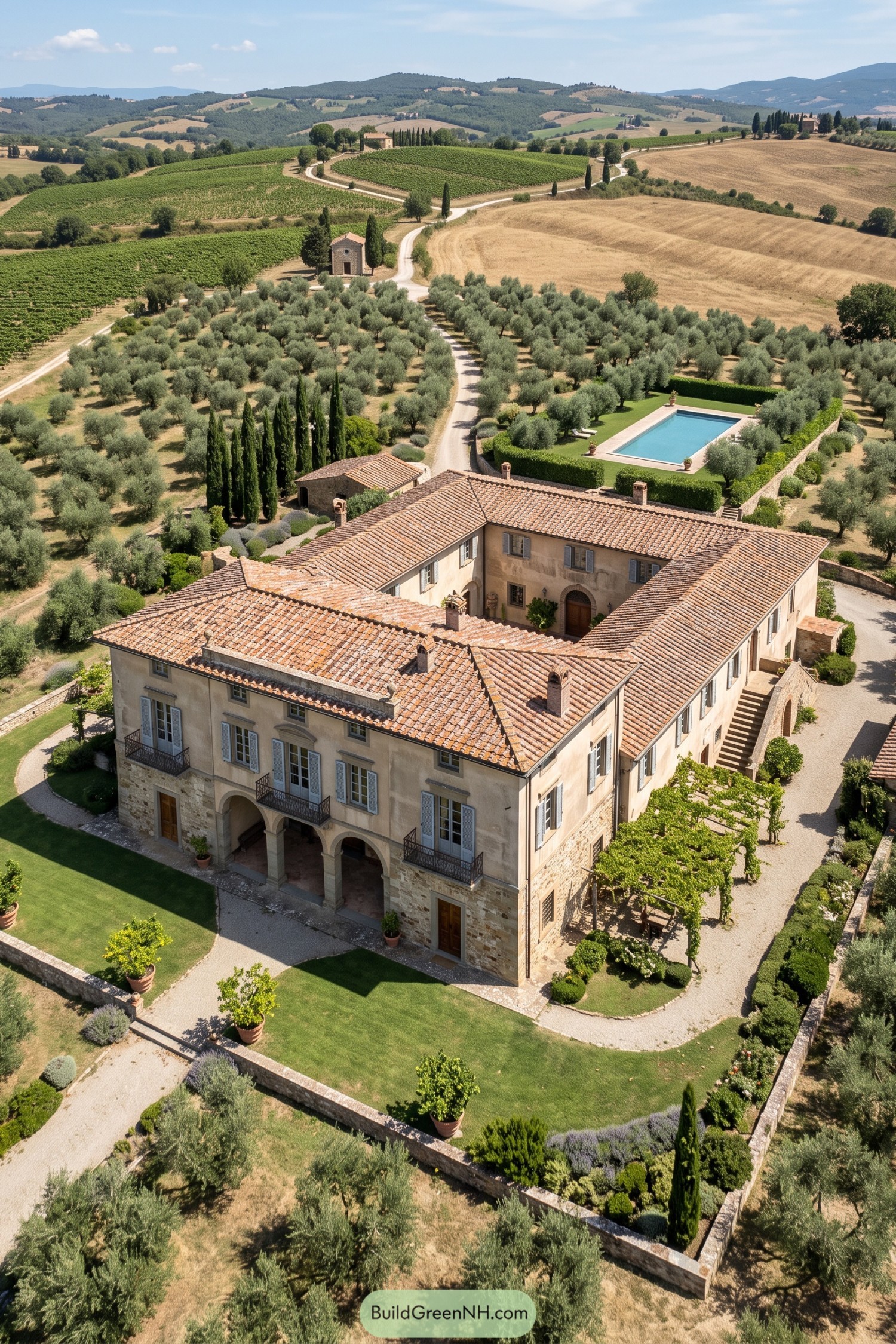 Tuscan manor with terracotta roofs amid olive groves and vineyards