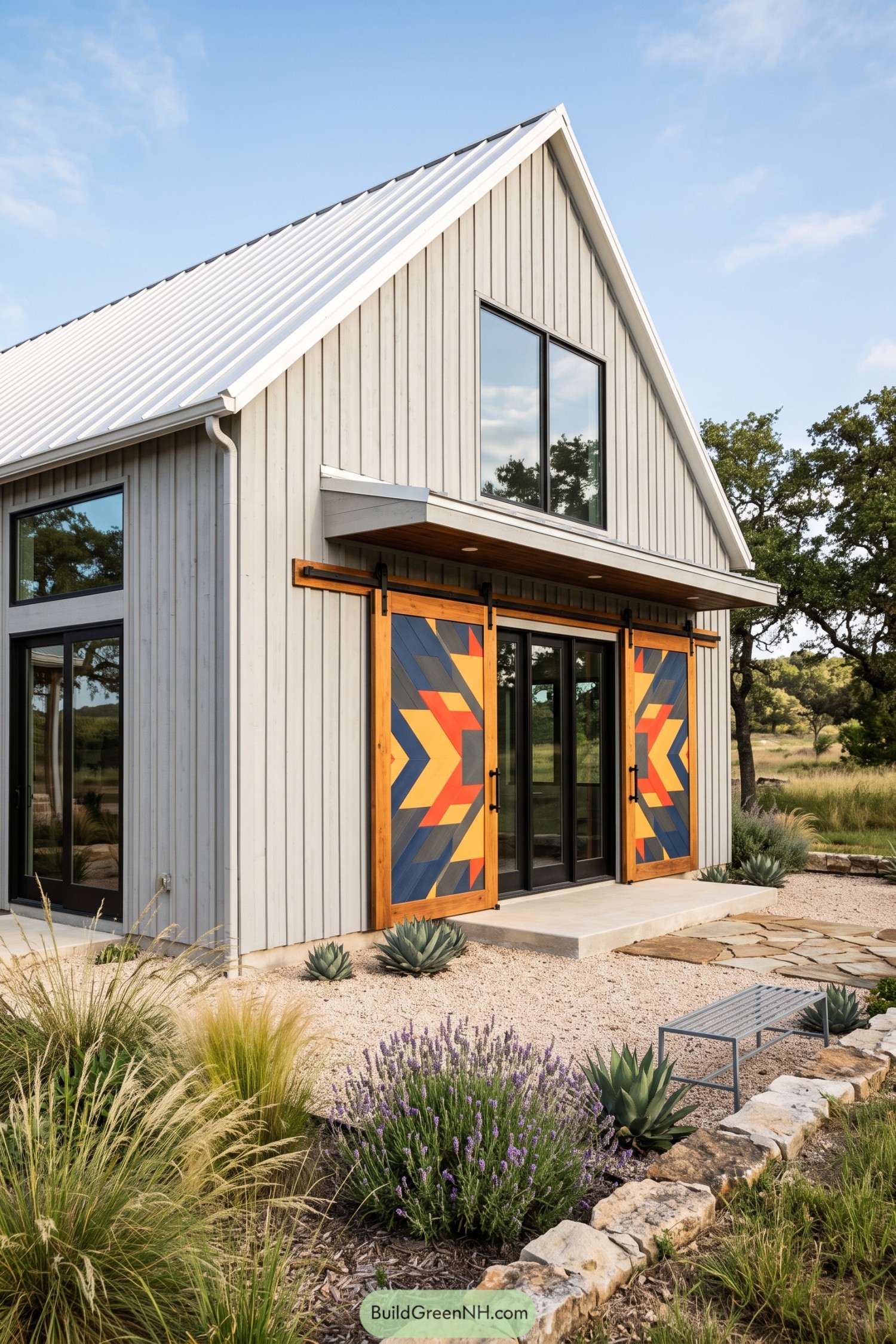 Modern barndominium with colorful chevron barn doors and white metal roof