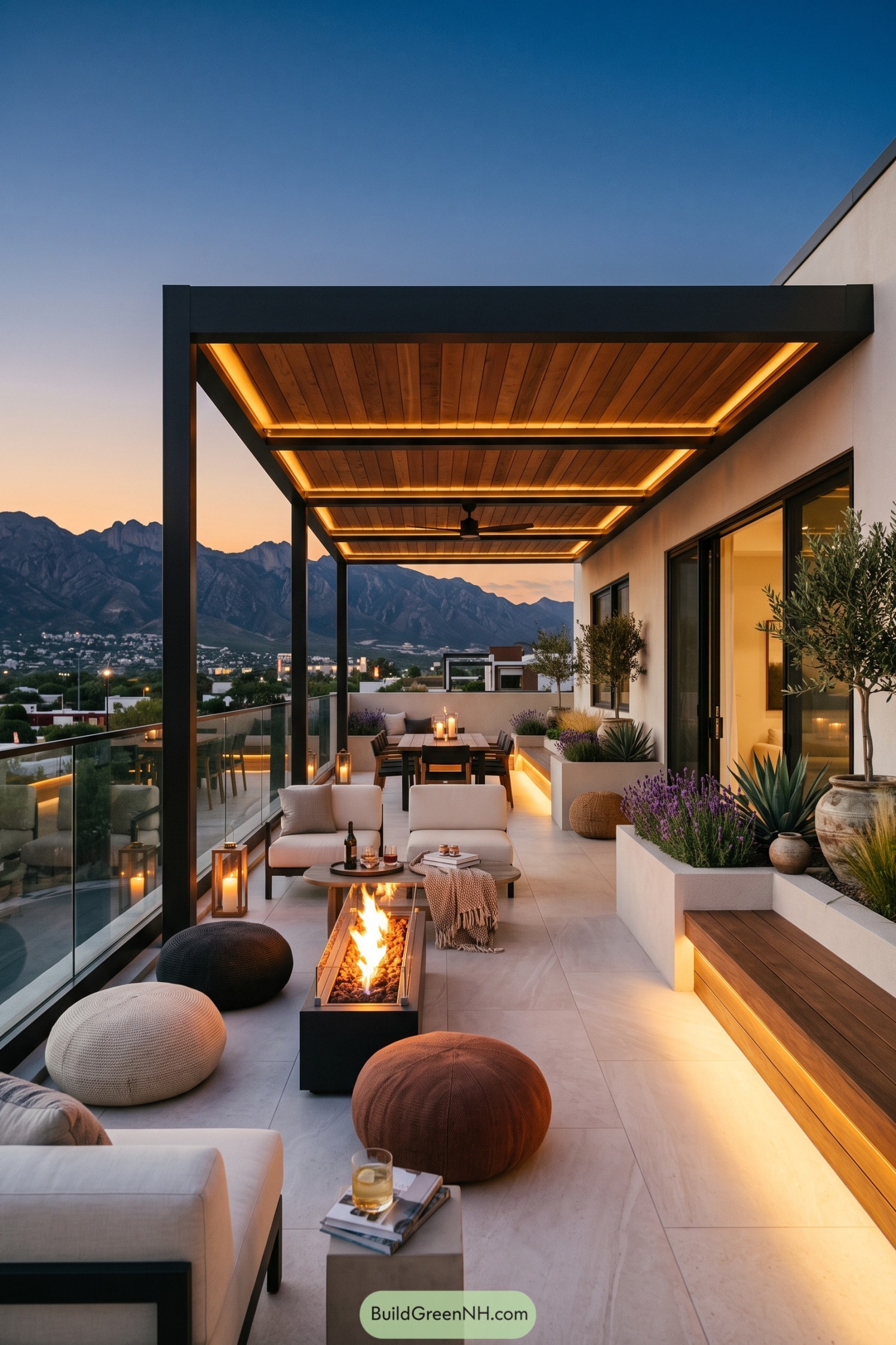 Modern rooftop patio with a fire table and mountain views at dusk