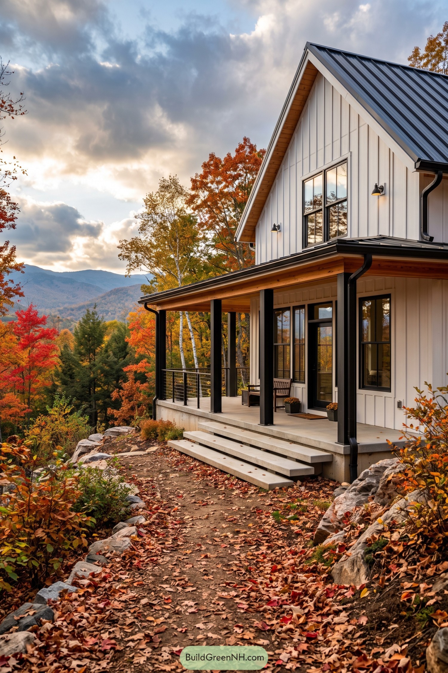 White barn house with black trim and mountain porch