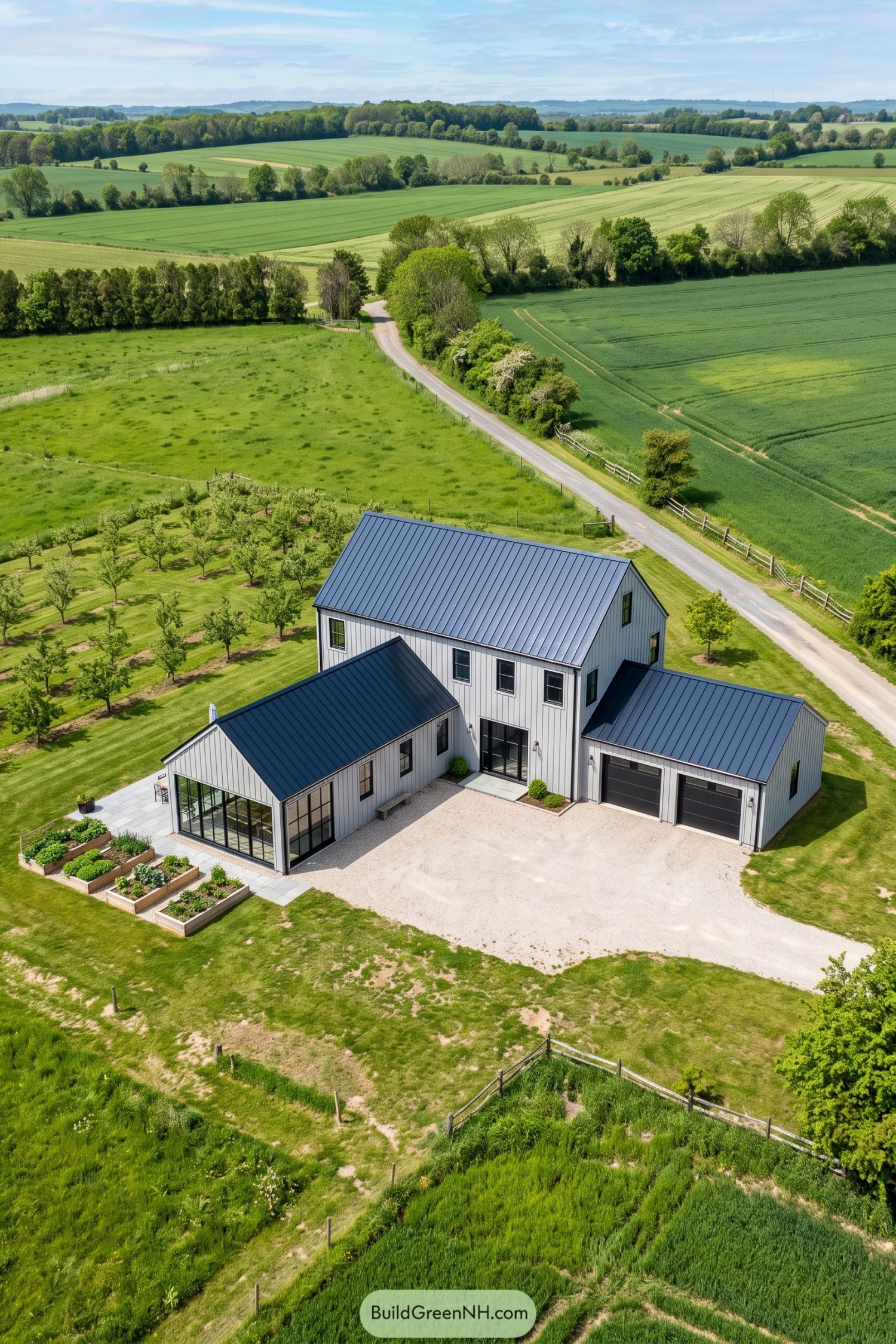 White barn house with black roofs and side wings beside an orchard