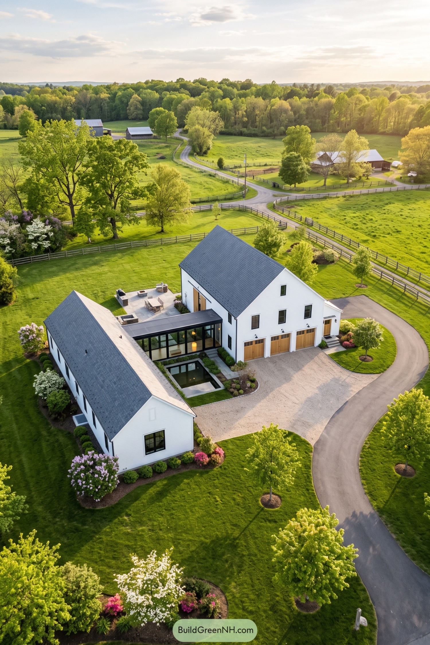 White gabled barn home with glass connector wings