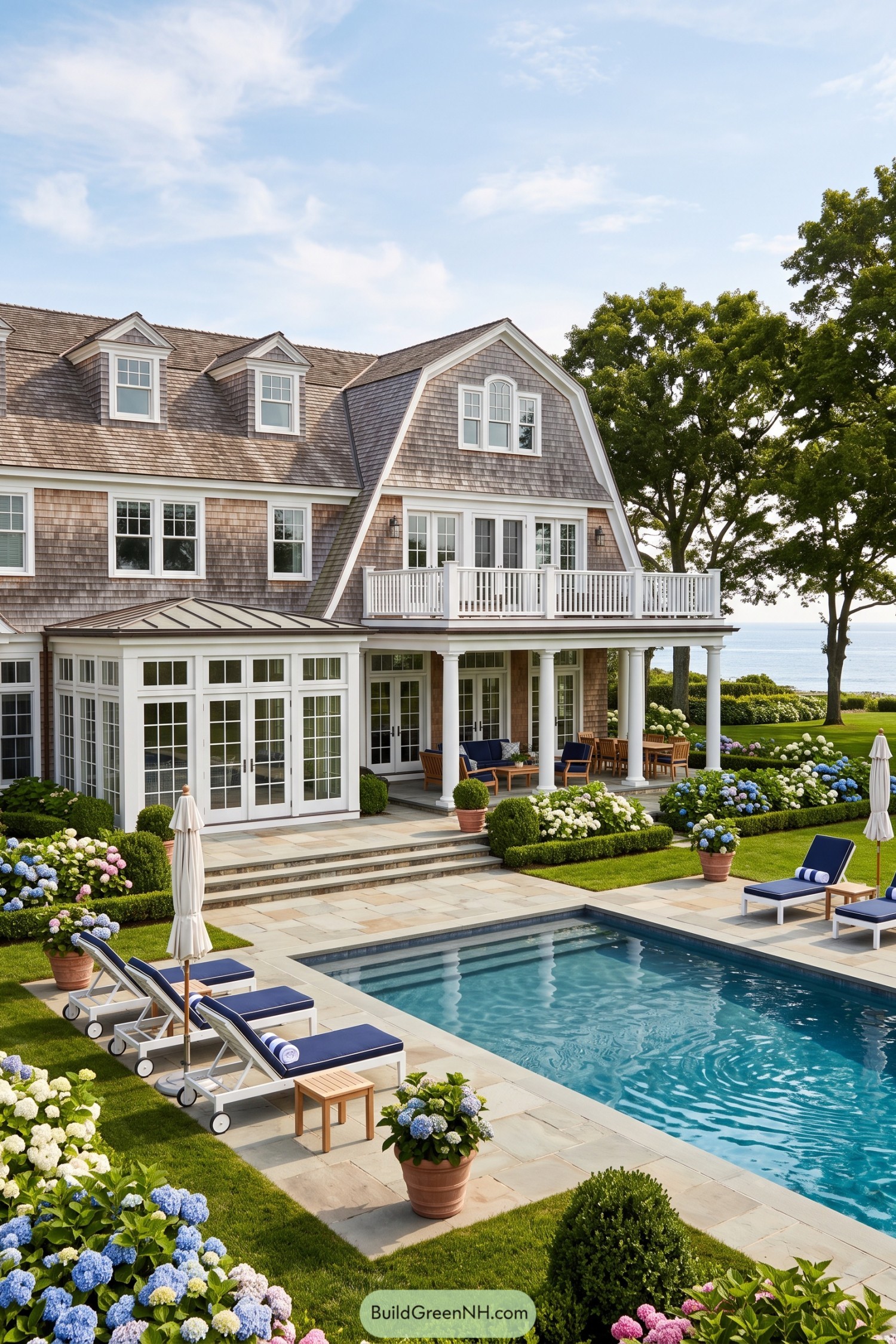 Shingled coastal home with pool terrace and ocean views