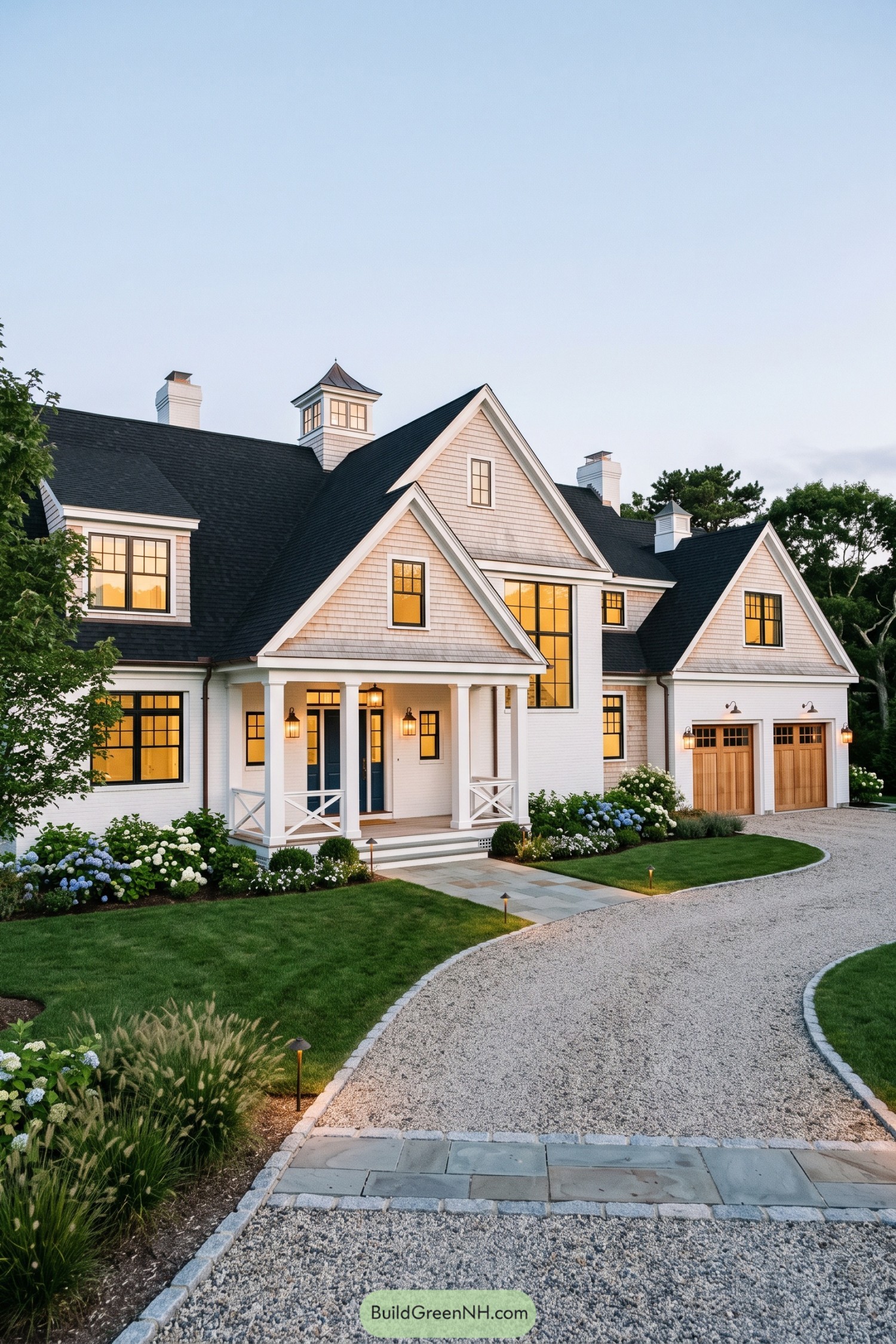 White shingle farmhouse with steep gables and cupola